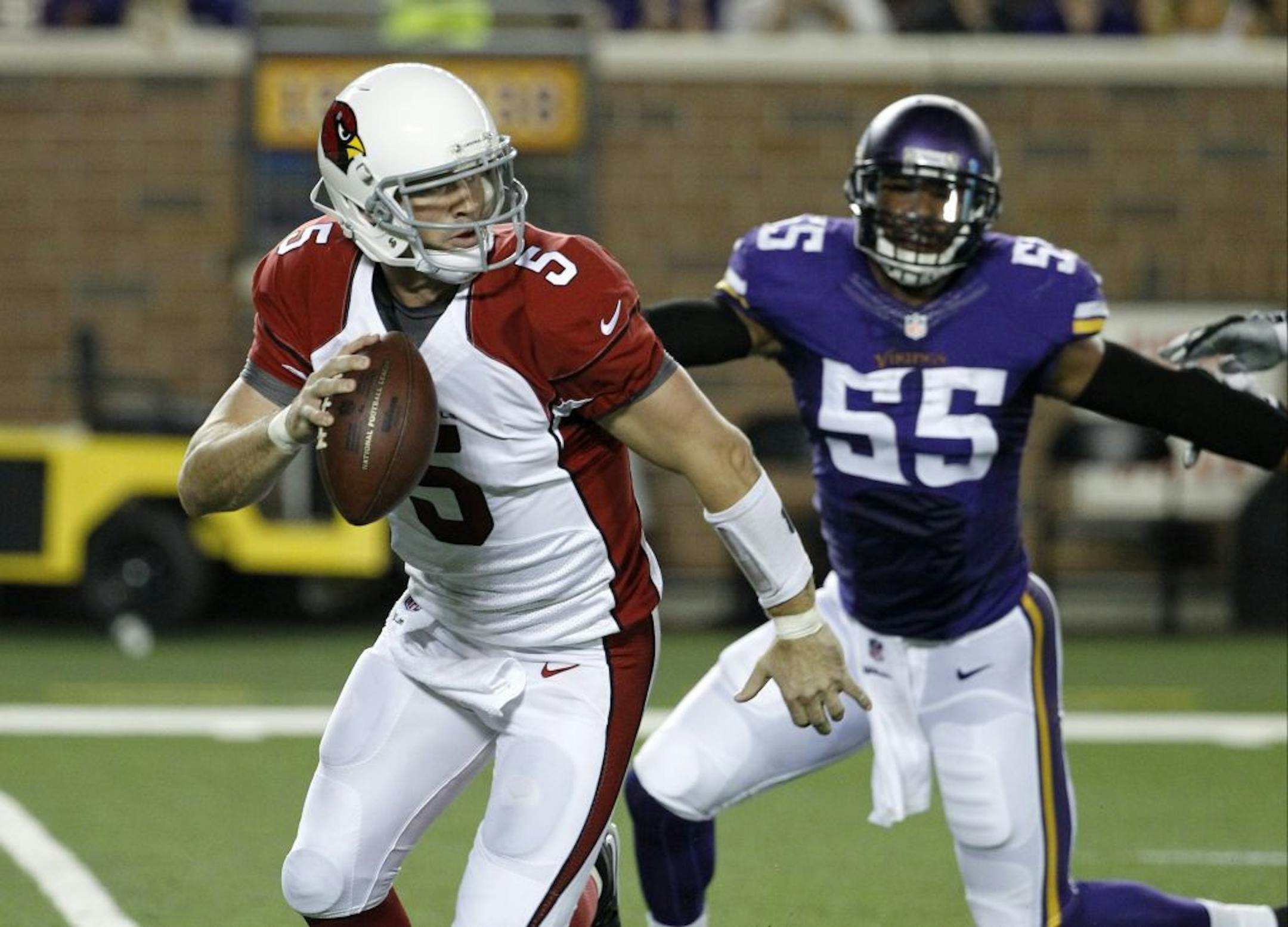 Arizona Cardinals quarterback Drew Stanton runs from Minnesota Vikings outside linebacker Anthony Barr (55) during the first half of an NFL preseason football game, Saturday, Aug. 16, 2014, in Minneapolis.