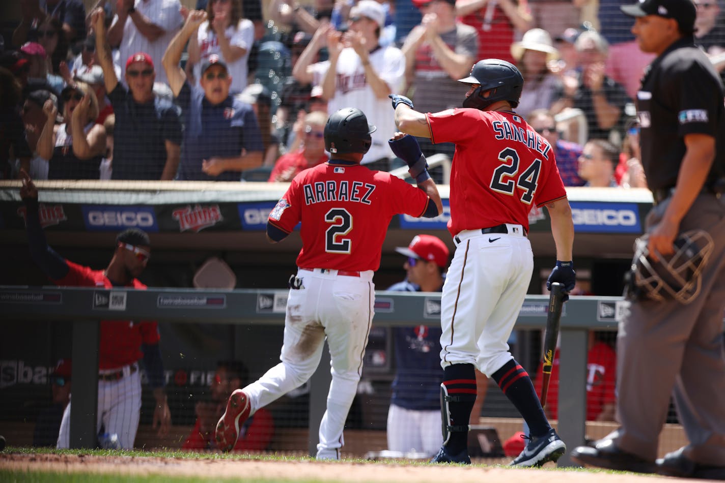 Minnesota Twins' Luis Arraez (2) reacts after scoring on a single line drive hit by Max Kepler during the first inning of a baseball game against the Cleveland Guardians, Sunday, May 15, 2022, in Minneapolis. (AP Photo/Stacy Bengs)