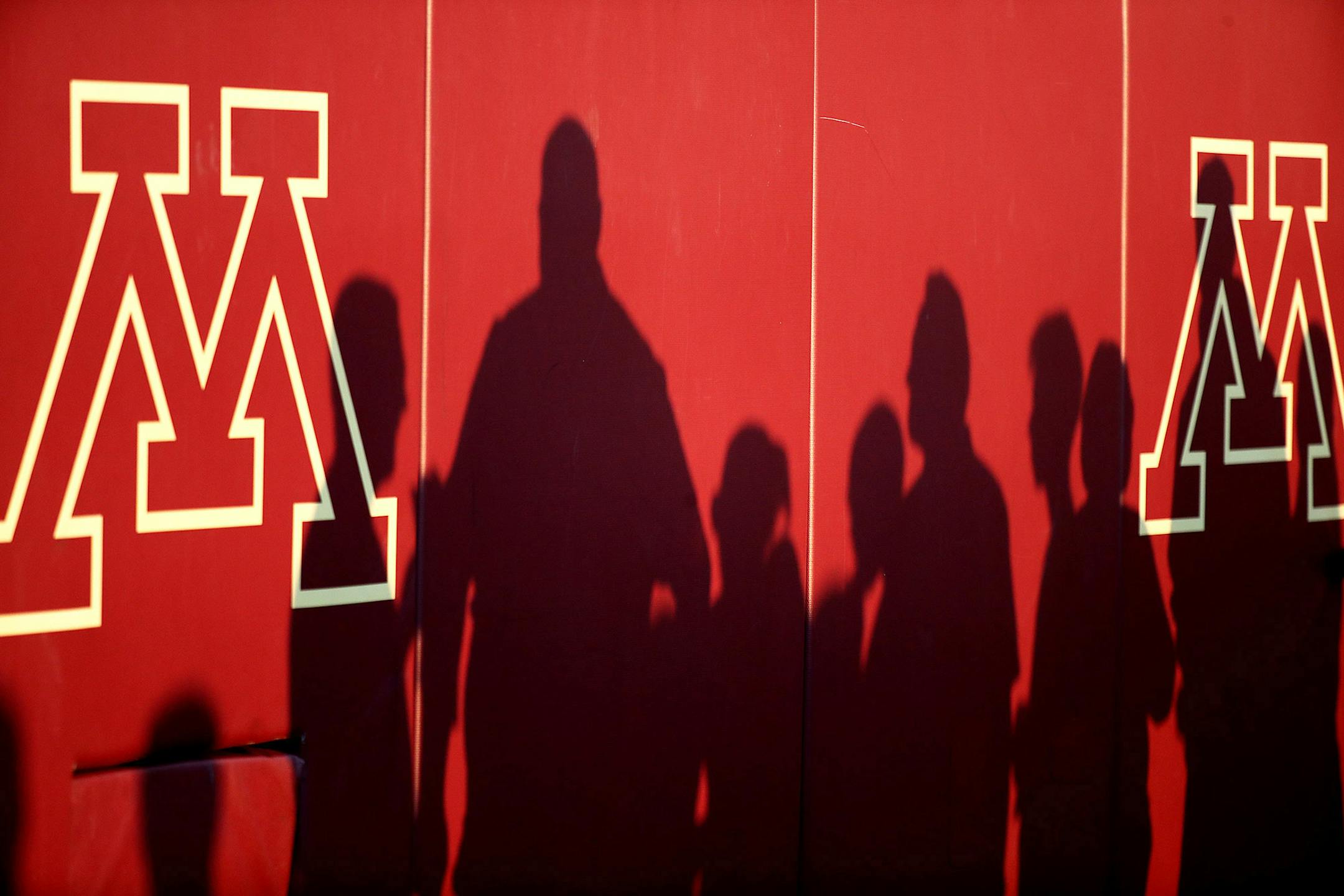 As the sun set, fans were shadowed on the wall as they watched the team warm-up before the Gophers took on Oregon State at TCF Bank Stadium in September 2016.