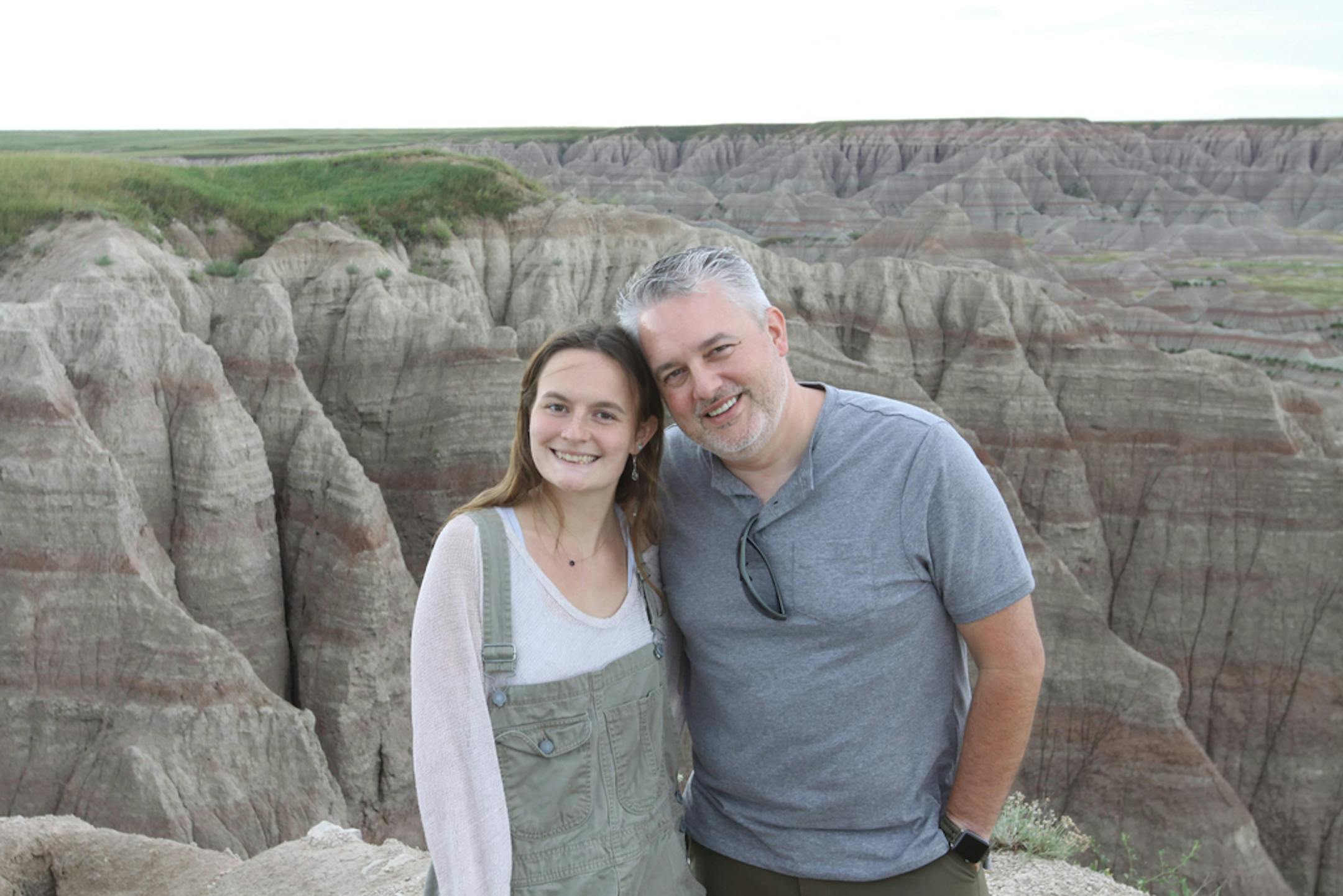In an image provided by The Roth Family, Zoë Roth and her father, Dave, in Badlands National Park in 2019. After more than a decade of having her image endlessly repurposed as a vital part of meme canon, Zoë has sold the original copy of her meme as a nonfungible token, or NFT, for nearly half a million dollars. (The Roth Family via The New York Times) — NO SALES; FOR EDITORIAL USE ONLY WITH NYT STORY DISASTER GIRL NFT BY MARIE FAZIO FOR APRIL 29, 2021. ALL OTHER USE PROHIBITED. —