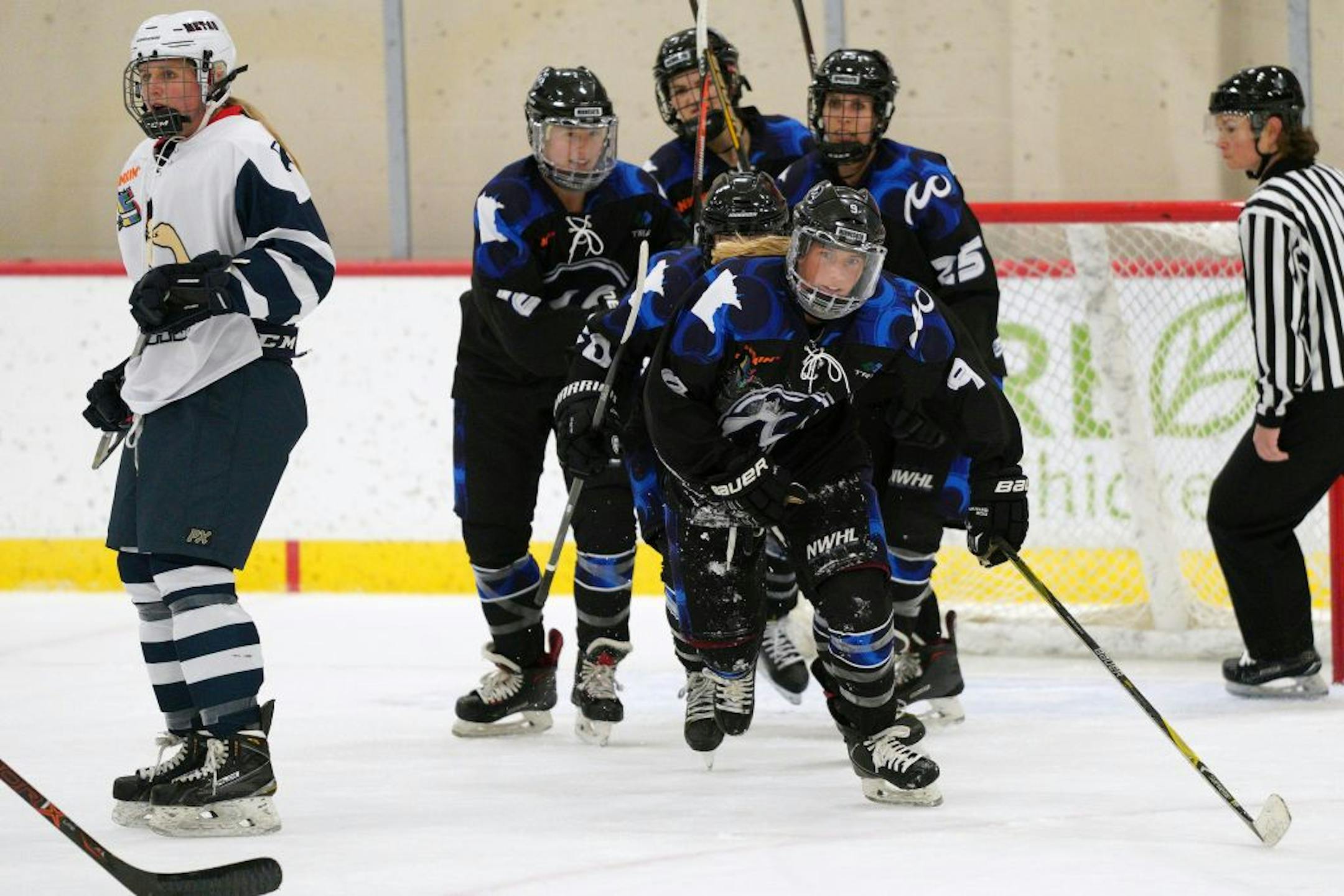Whitecaps forward Allie Thunstrom (9) skated back to celebrated with her teammates on the bench after she scored a goal during Saturday's game.