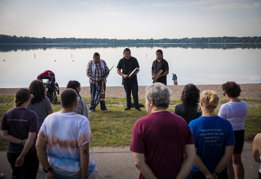 Daryl Kootenay, Thorne LaPointe and Wakinyan LaPointe led a crowd in a prayer session and song on the north shore of Bde Maka Ska at the Four Sacred Directions Water Walk in 2017.