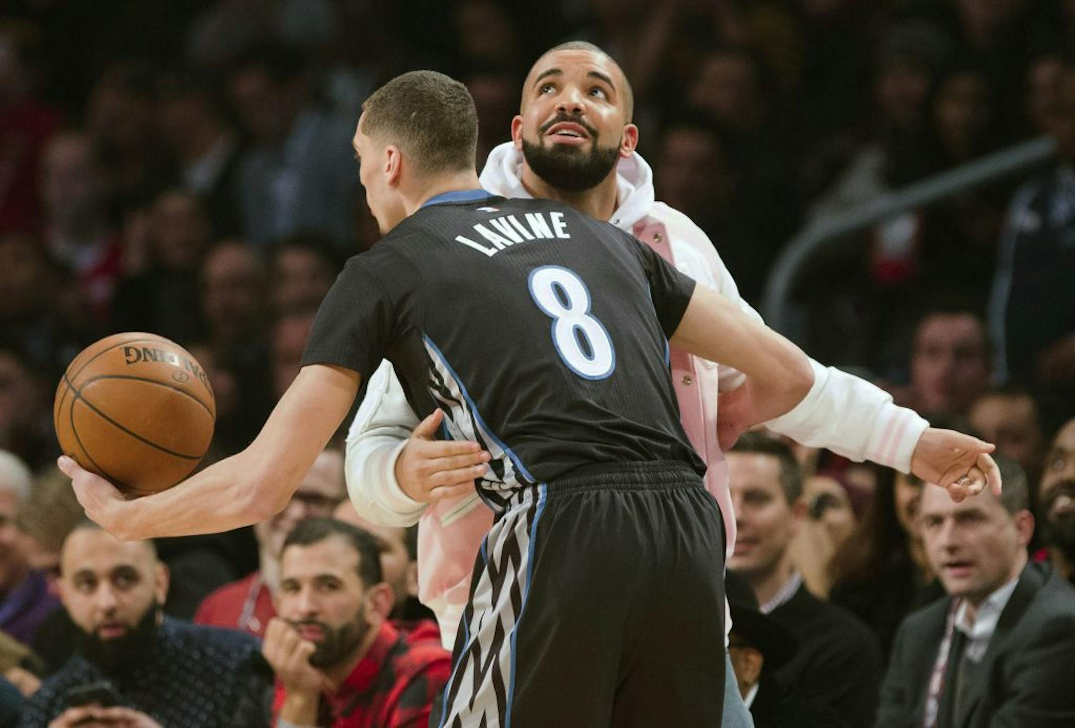 Minnesota Timberwolves Zach LaVine hugs rapper Drake during the NBA all-star slam dunk skills competition in Toronto on Saturday, Feb. 13, 2016. (Mark Blinch/The Canadian Press via AP) MANDATORY CREDIT