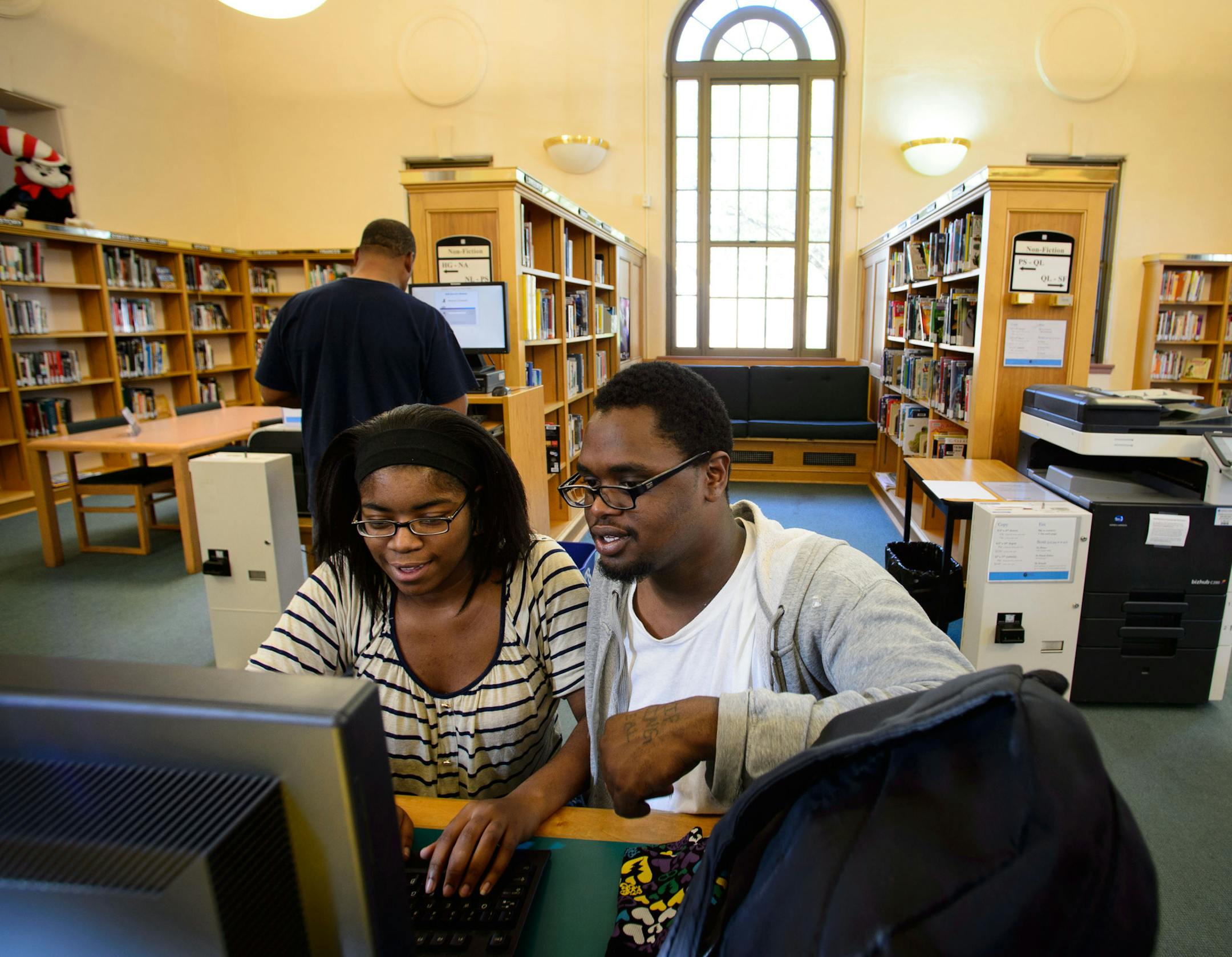 Dominique Johnson, left, helped her friend Dominique Nicholas learn keyboarding on a computer in Arlington Hills Library. The St. Paul Public Library System is seeking a new owner for the Arlington Hills Library, one of three Carnegie libraries in the city and built in 1916 and listed on the National Register of Historic Places, who will retain it as a neighborhood and cultural asset. The library itself is moving to modern quarters on the East SIde. Thursday, October 10, 2013 ] GLEN STUBBE * gst
