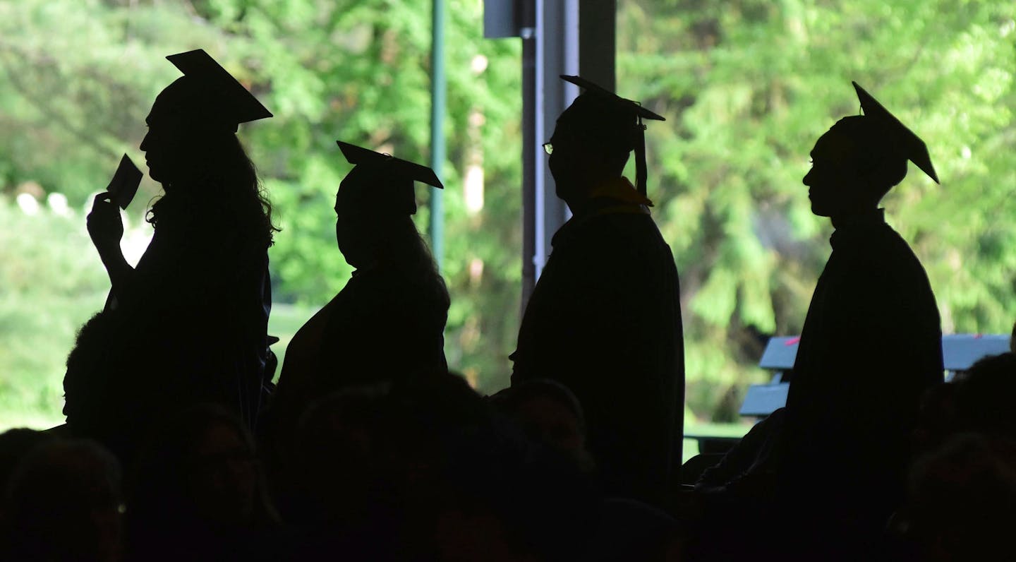 Dr. Anthony Fauci and Scott Z. Burns speak to Minnesota grads