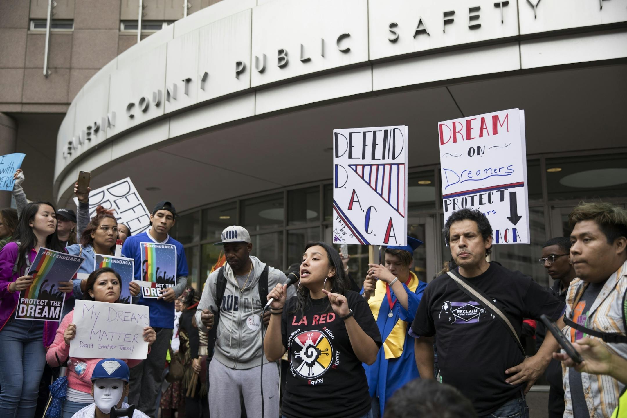 Catalina Morales used a microphone to speak to the crowd in front of the Hennepin County Jail after marching through Minneapolis in protest after President Donald Trump announced his plans to rescind DACA on Tuesday, September 5, 2017, Minneapolis, Minn.