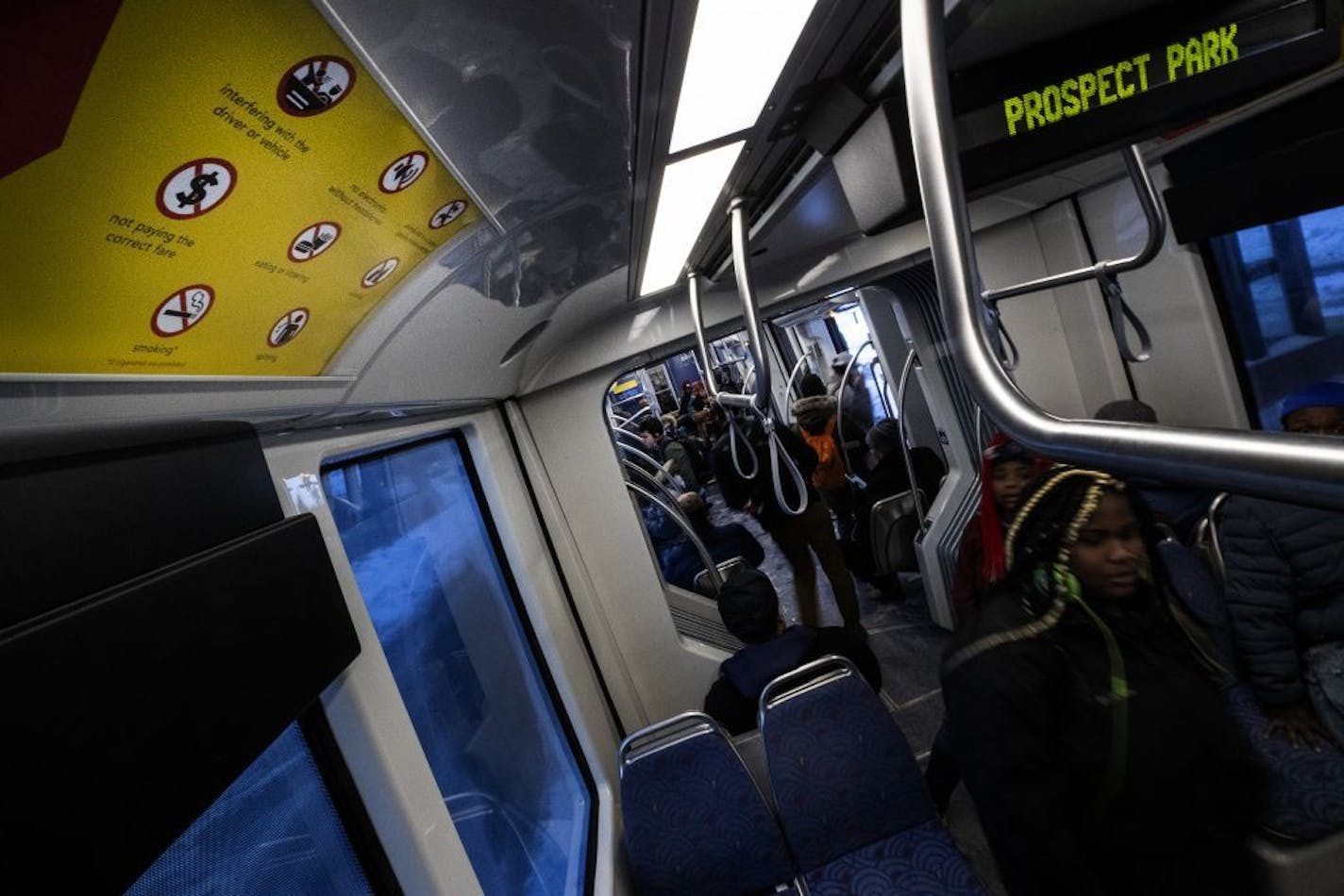 A sign notes that smoking is among the activities and things prohibited on a Metro Transit light rail Green Line train.