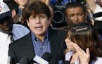 FILE - In this March 14, 2012, file photo, former Illinois Gov. Rod Blagojevich speaks to the media outside his home in Chicago as his wife, Patti, wi