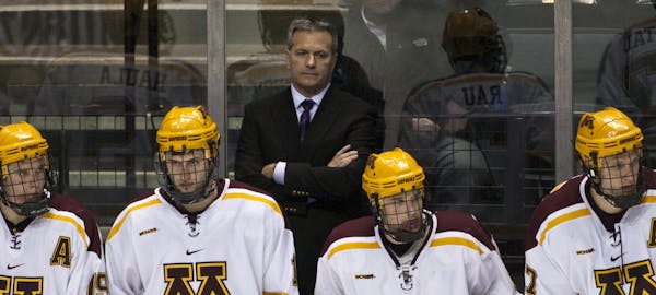 Minnesota's bench and head coach Don Lucia watches during the game against Yale during the NCAA Division I Hockey college regional tournament game in 
