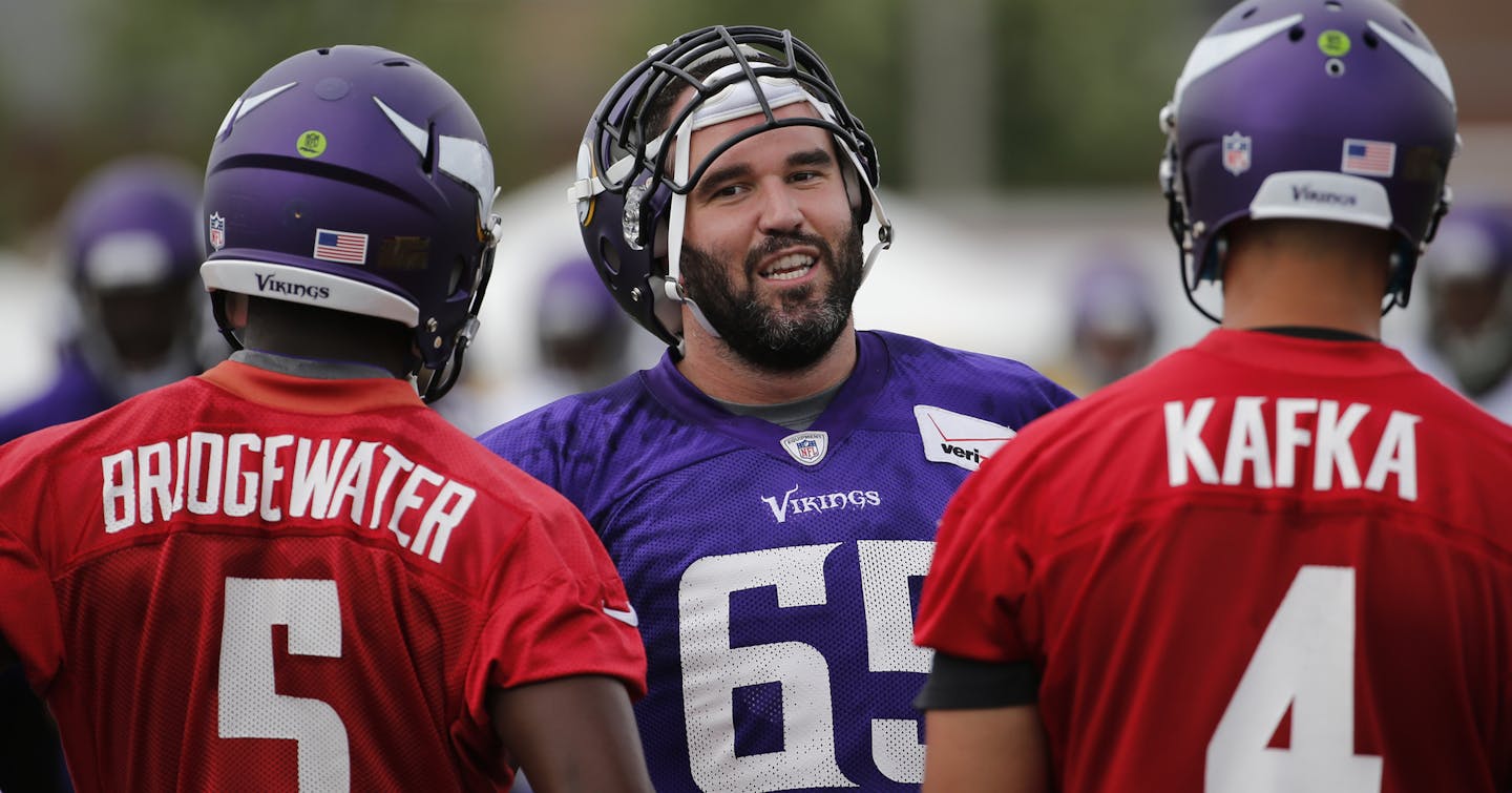 Minnesota Vikings center John Sullivan (65) talks to quarterbacks Teddy Bridgewater and Mike Kafka, during practice at an NFL football training camp on the campus of Minnesota State University Monday, July 27, 2015, in Mankato, Minn. (AP Photo/Charles Rex Arbogast)