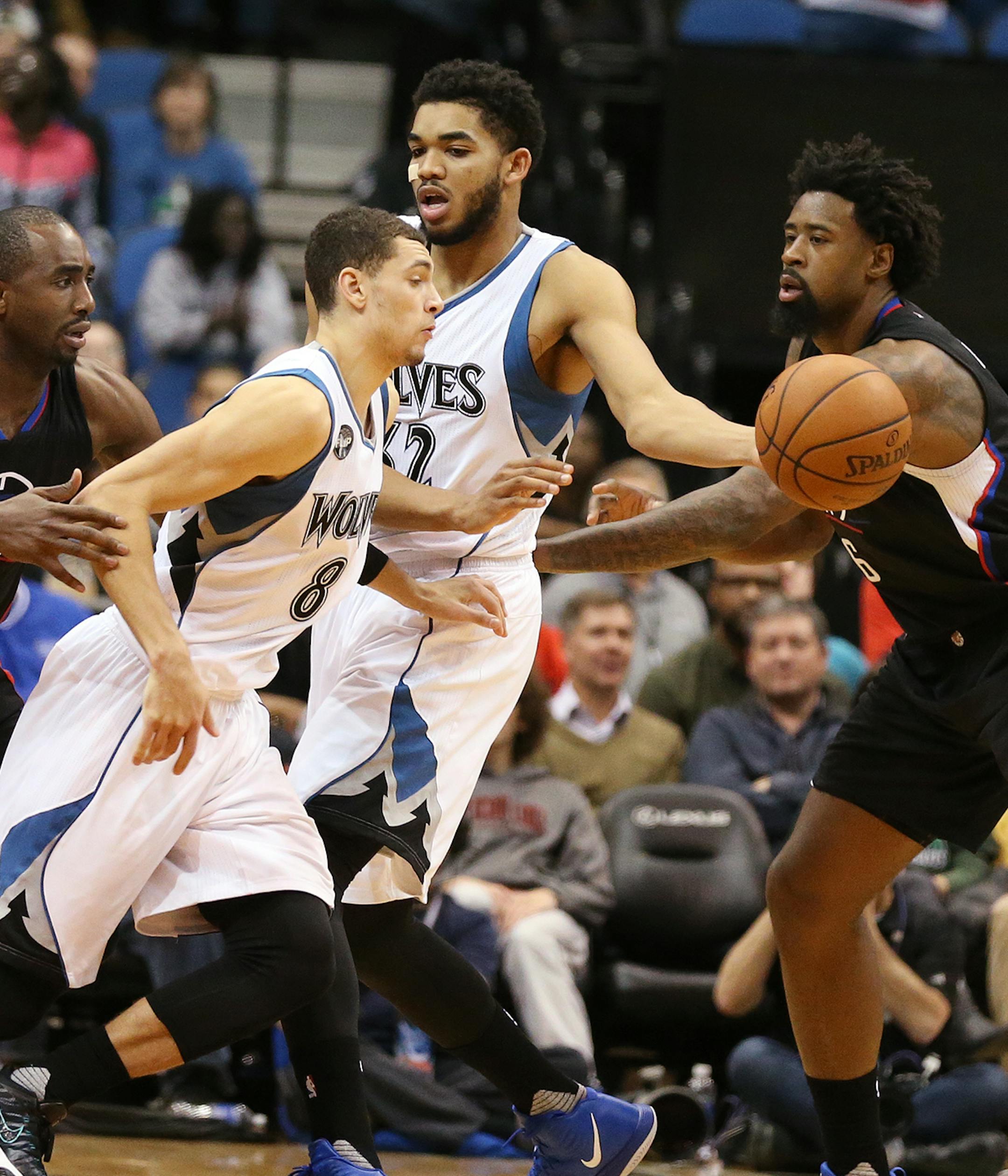 Minnesota Timberwolves center Karl-Anthony Towns (32), center, passes the ball to Minnesota Timberwolves guard Zach LaVine (8) with Los Angeles Clippers forward Luc Richard Mbah a Moute (12), left, and Los Angeles Clippers center DeAndre Jordan (6), right, defending during the second half. ] (Leila Navidi/Star Tribune) leila.navidi@startribune.com BACKGROUND INFORMATION: The Minnesota Timberwolves play the Los Angeles Clippers at Target Center in Minneapolis on Monday, December 7, 2015. Los Ange