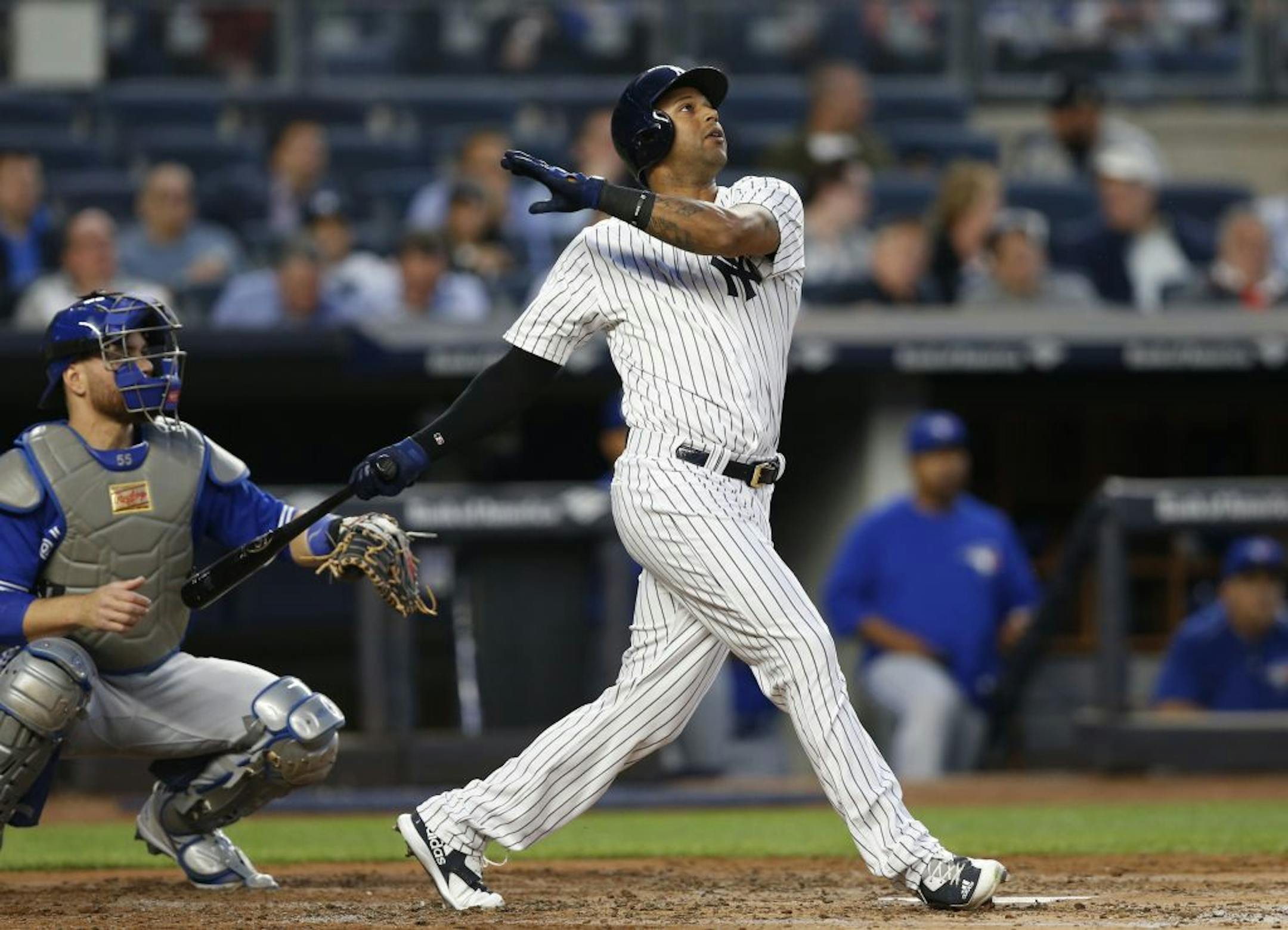 New York Yankees' Aaron Hicks watches his second-inning two-run home run against the Toronto Blue Jays in a baseball game in New York, Tuesday, May 2, 2017.
