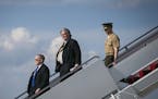 FILE &#x2014; Steve Bannon, center, President Donald Trump's chief strategist, arrives on Air Force One at Joint Base Andrews in Maryland, April 28, 2