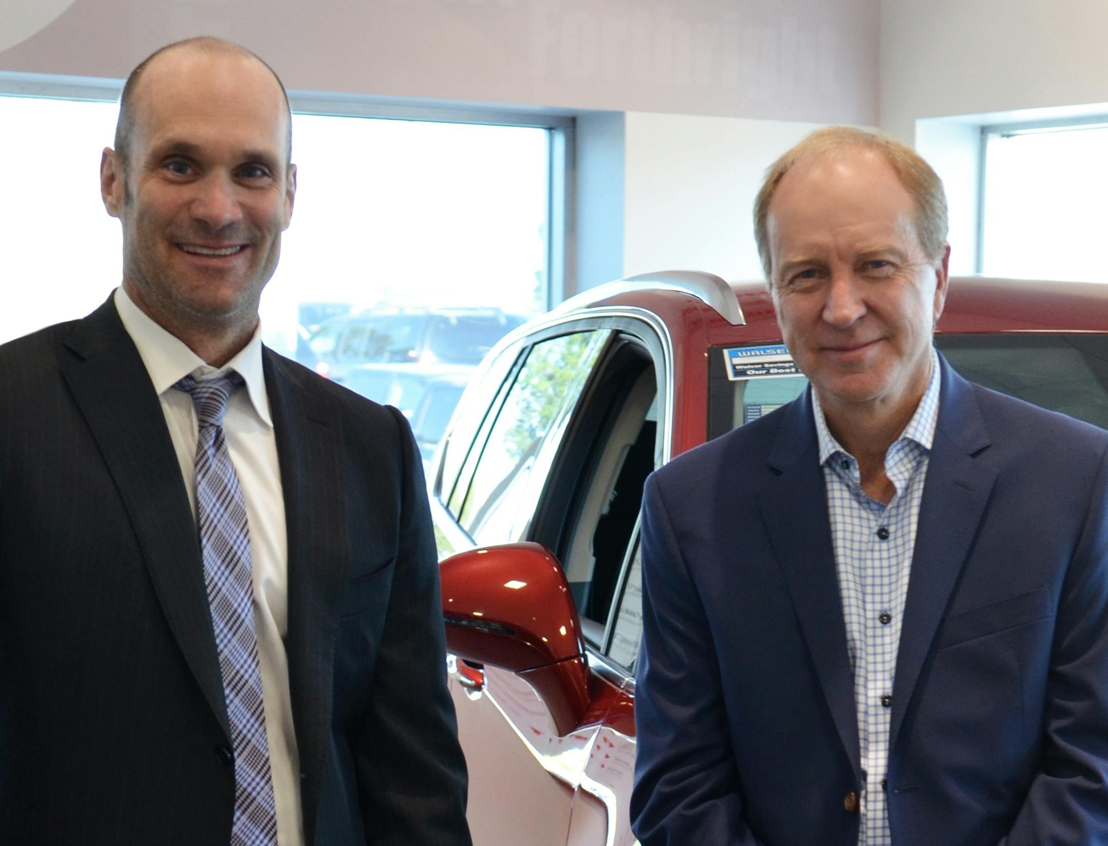 Paul Walser (right), longtime CEO of Walser Automotive Group, is stepping down. His brother, Andrew, will succeed him. (Provided photo)