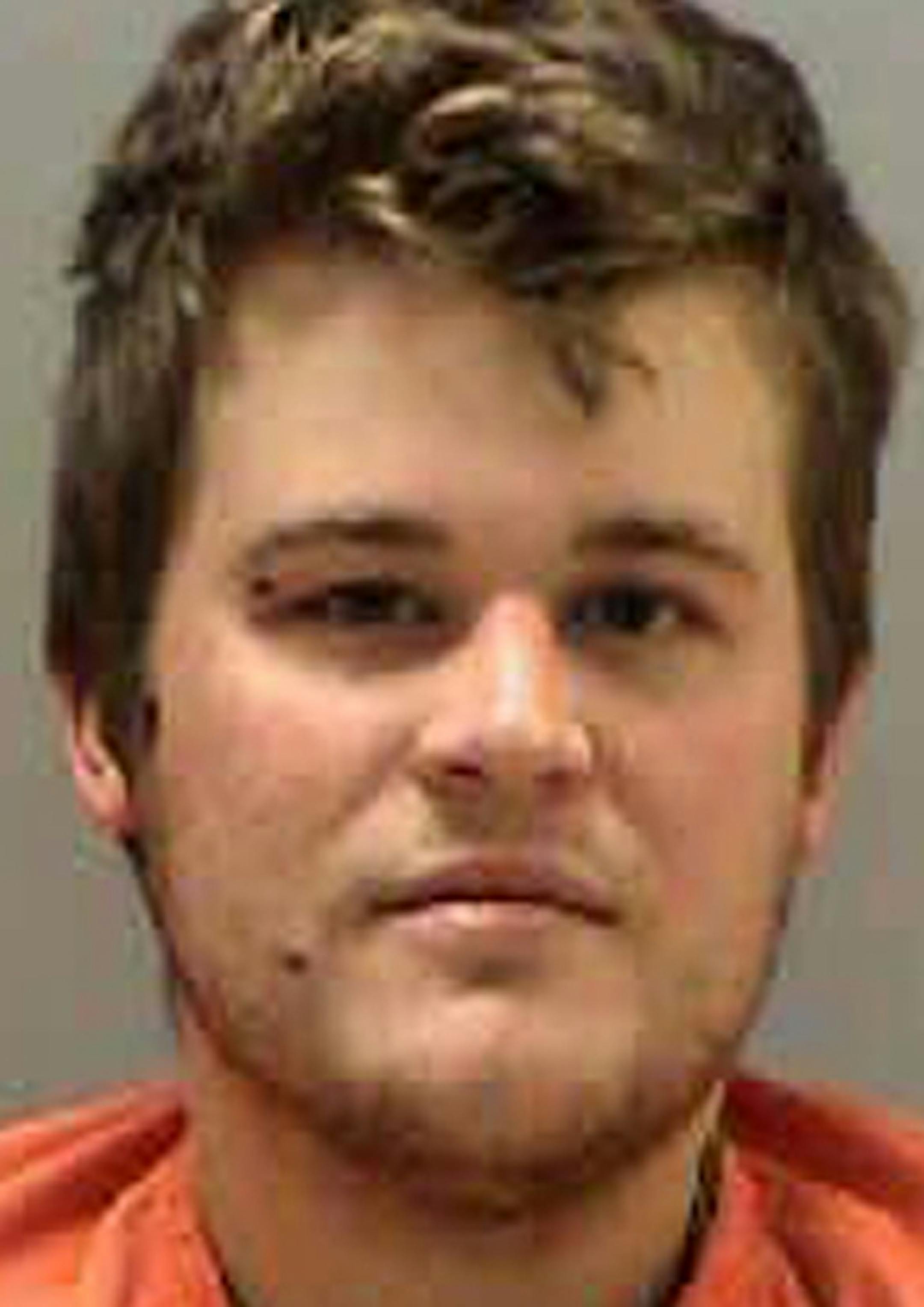This photo provided by the Northwest Regional Corrections Center shows Michael Jon Perry. The 23-year-old man is charged with attempted murder for a shootout with police in northwestern Minnesota. The state Bureau of Criminal Apprehension says Perry of Crookston is charged with four counts of attempted first-degree murder of a peace officer. Perry appeared in court Friday, Sept. 19, 2014. Unconditional bail was set at $1 million cash. (AP Photo/Northwest Regional Corrections Center)