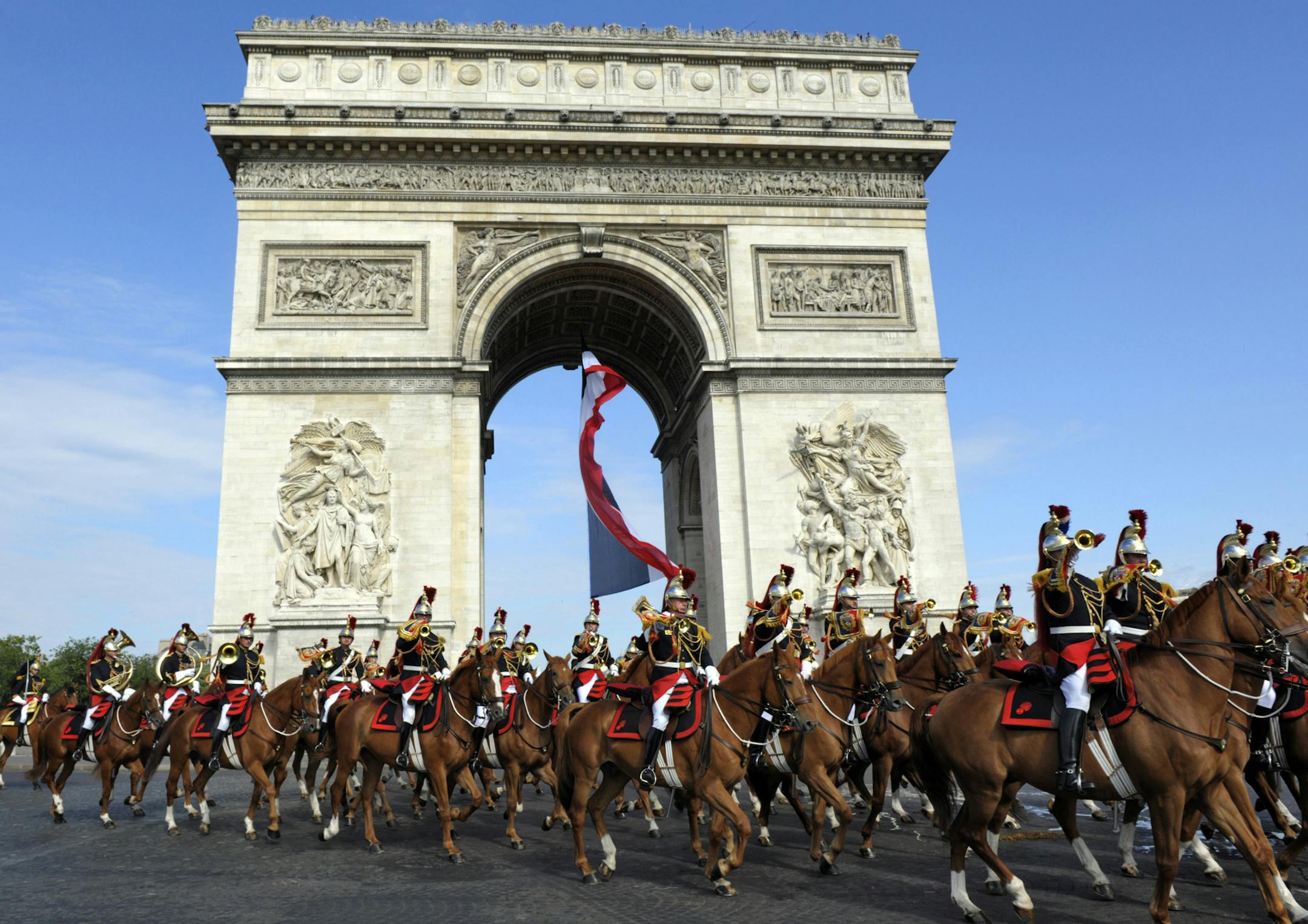 Republican Guards ride past the Arc de Triomphe during the traditional Bastille Day parade in Paris, Thursday, July 14, 2011. France celebrated its annual Bastille Day celebrations on Thursday with a traditional military parade along the Champs-Elysees. The celebration commemorates the storming of the Bastille prison on 14 July 1789, which symbolised the birth of modern France. (AP Photo/Philippe Wojazer, Pool)