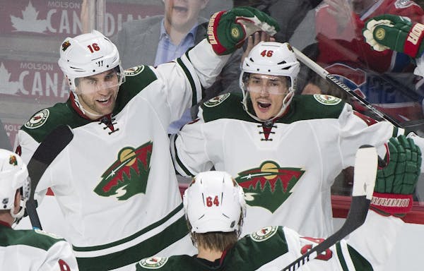 Minnesota Wild's Jared Spurgeon (46) celebrates with teammates Jason Zucker (16) and Mikael Granlund after scoring against the Montreal Canadiens duri