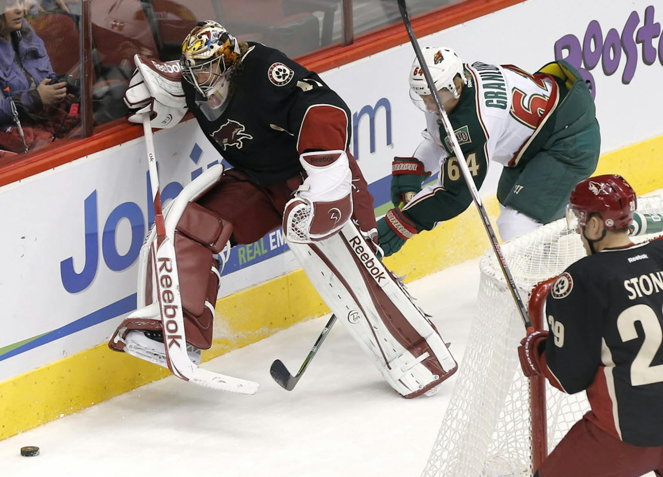 Phoenix goalie Mike Smith kicks the puck away from Minnesota's Mikael Granlund.
