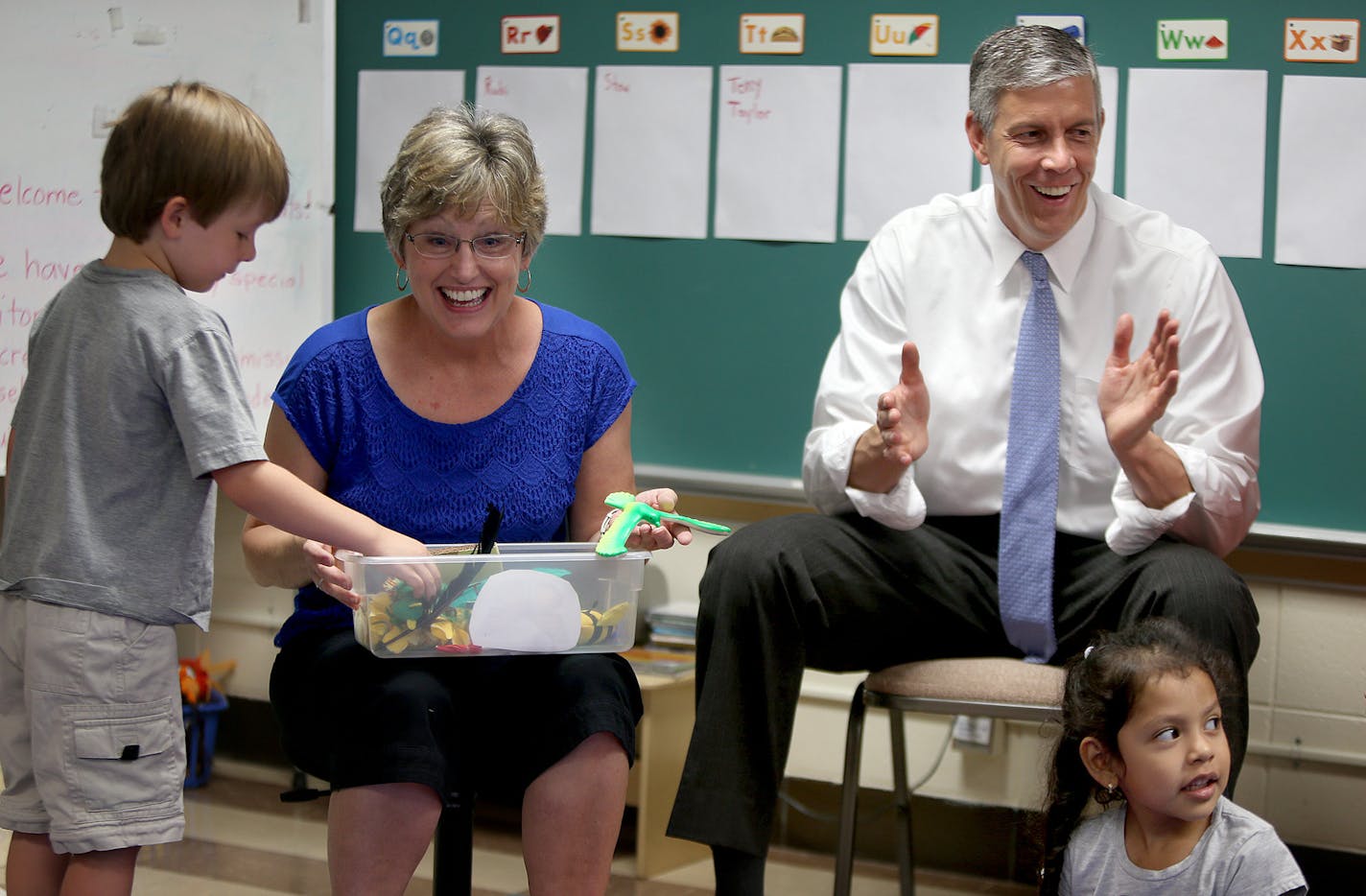 Education Secretary Arne Duncan, right, got to join Jody Bohrer's Kindersprouts circle time during his Minnesota visit along with students Brody Mallunger, left, and Rubi Torres, at Pond Early Childhood Center, Tuesday, July 16, 2013 in Minneapolis.