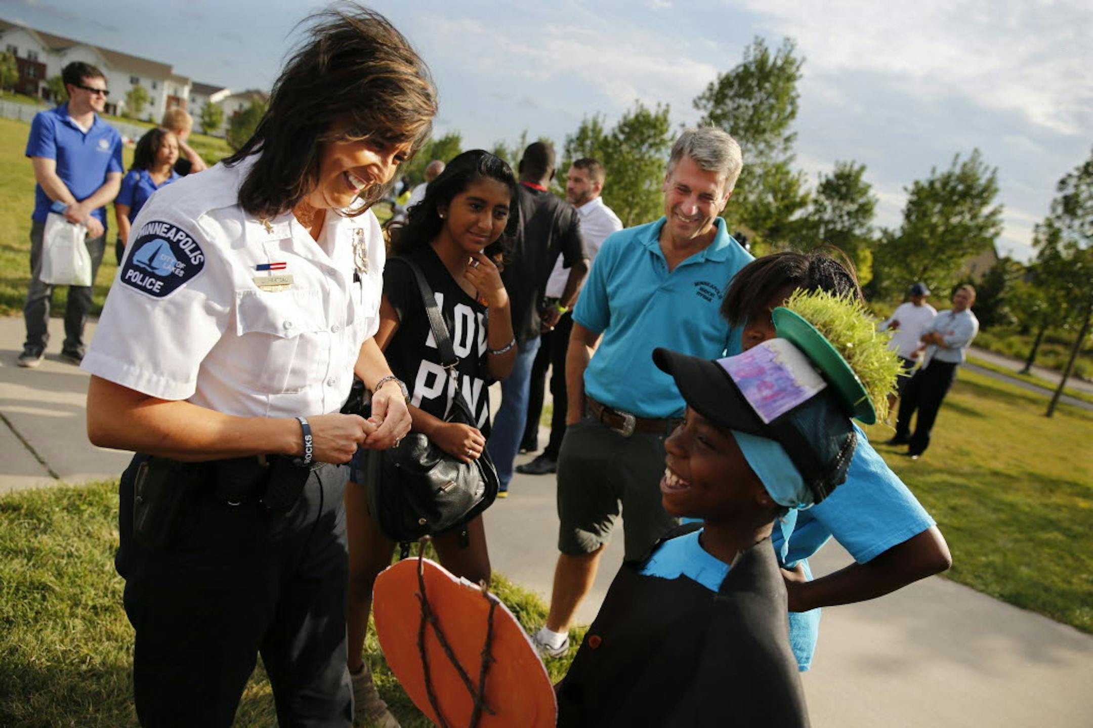 At National Night Out in the Heritage Park neighborhood in Minneapolis, Police Chief Janée Harteau, daughter Lauren, and Mayor R.T. Rybak enjoyed talking to the kids from the neighborhood