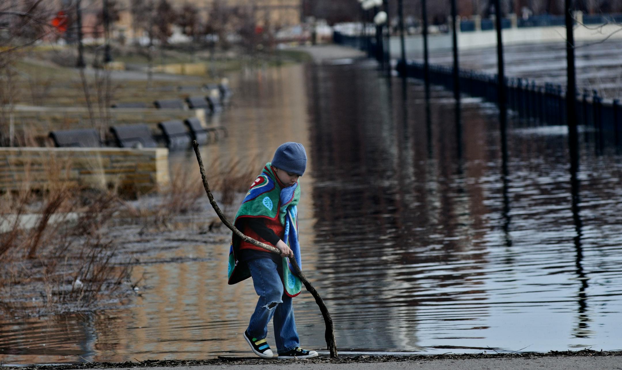 The rising Mississippi River has been attracting curious shore walkers. On a field trip with his mom, Jet Hecker, 7, of Bloomington, checks out the backwaters near Chestnut and Spring streets in St. Paul.