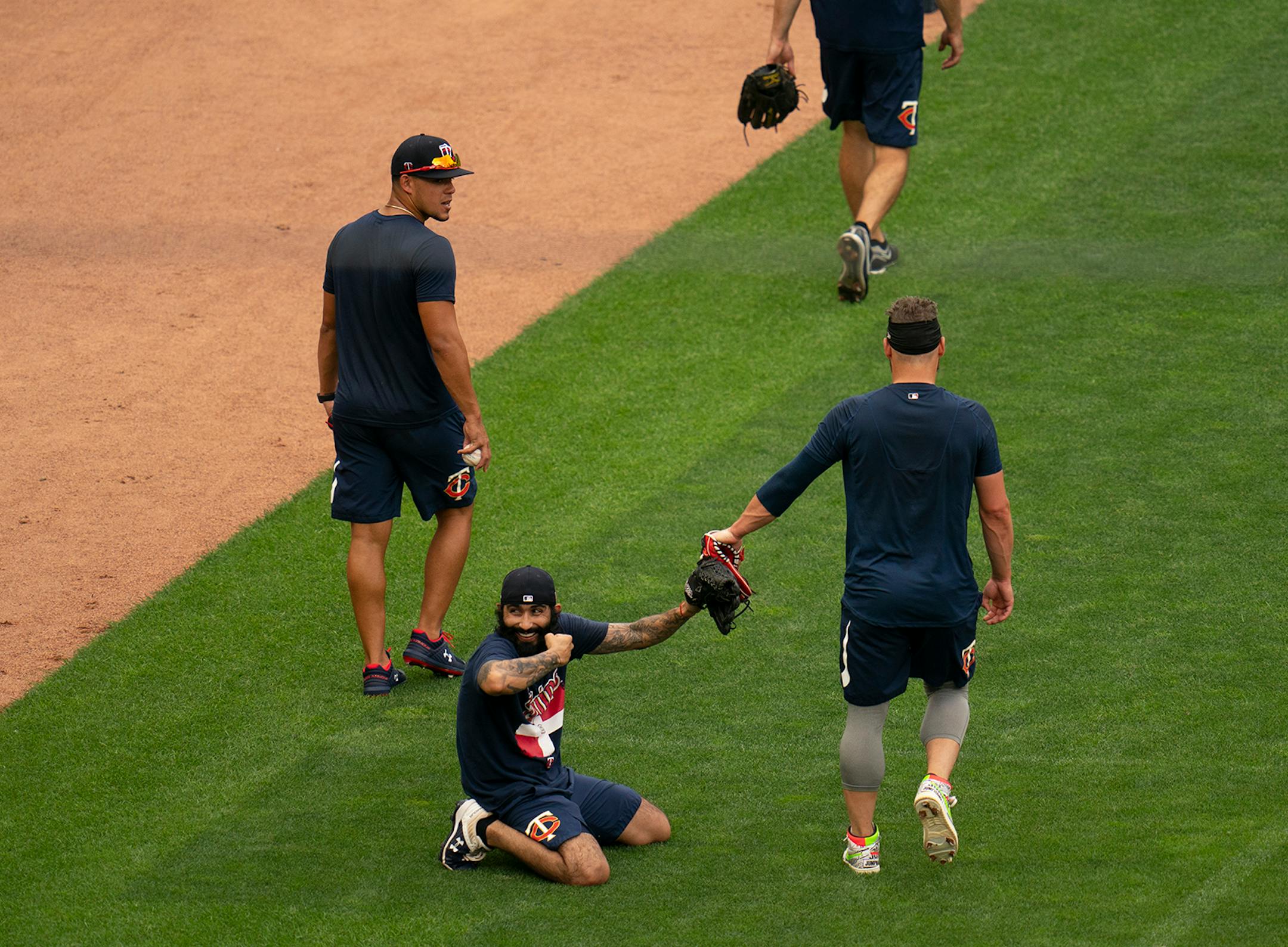 Minnesota Twins relief pitcher Sergio Romo touched gloves with Minnesota Twins third baseman Josh Donaldson while flexing as pitchers and infielders finished drills Monday afternoon. At left was Twins starter Jose Berrios.