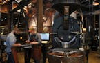 Brandon Cohen, left, roaster operator, and Shawn Sidey, master roaster, check Sitio Baixadao coffee as it's roasted at Starbucks Reserve Roastery. Bea