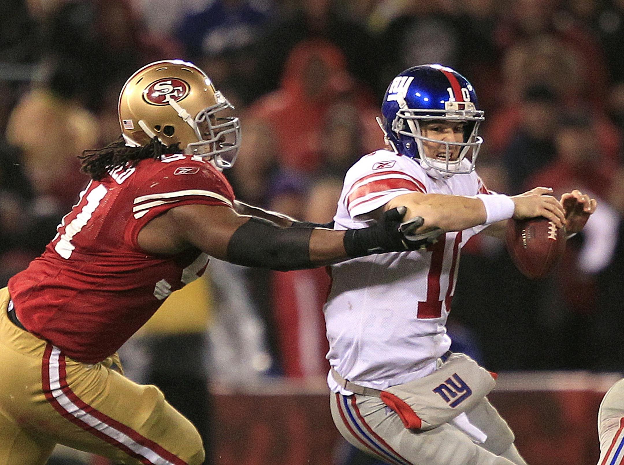 New York Giants quarterback Eli Manning is sacked by San Francisco 49ers' Ray McDonald (91) during the second half of the NFC Championship NFL football game Sunday, Jan. 22, 2012, in San Francisco.
