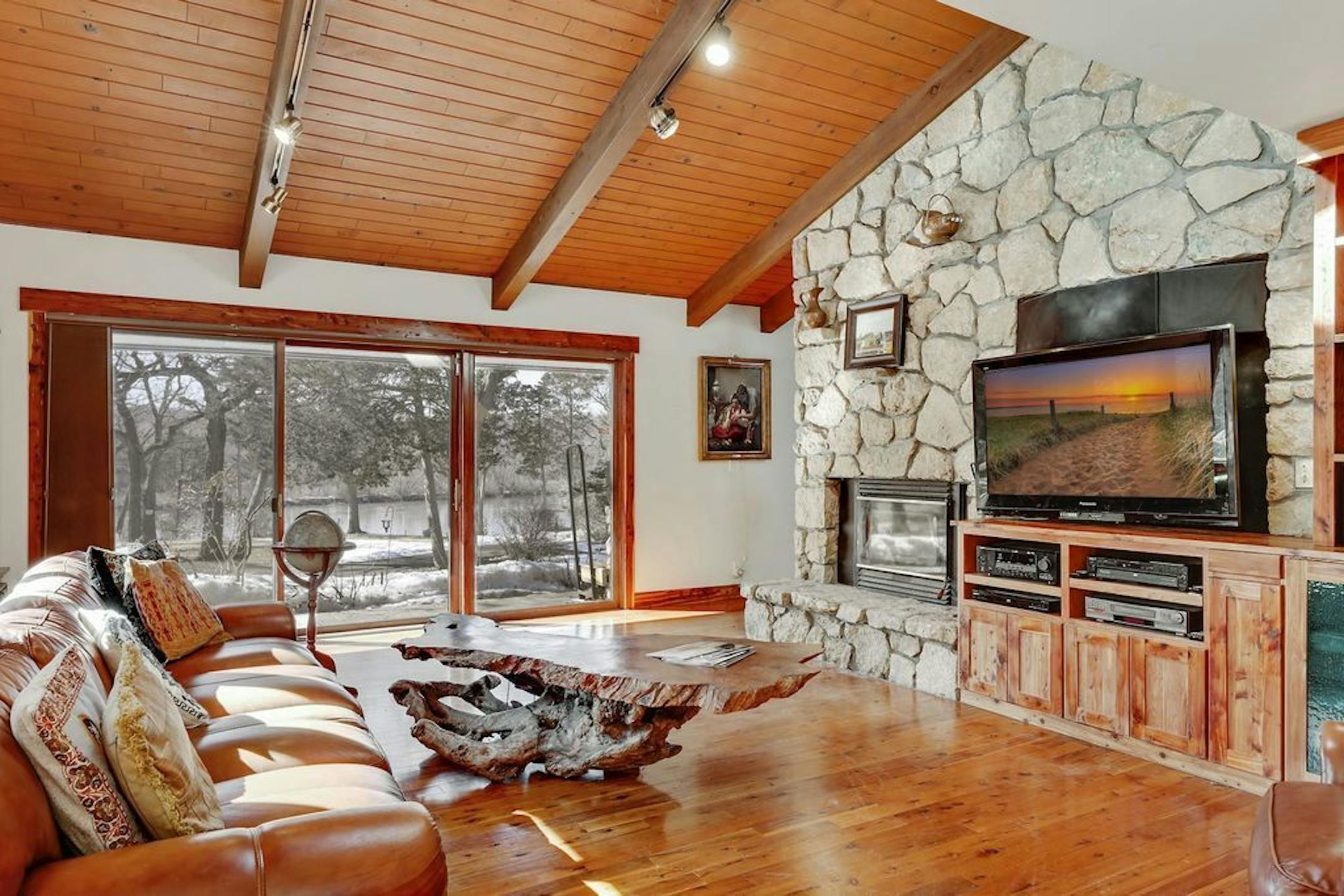 Two-sided fireplace divides the TV room and sitting room.