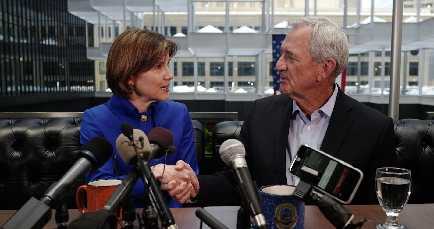 Attorney General Lori Swanson shakes hands with running mate Rick Nolan as they answered questions from the press about the decision to run for the governor's office at the Marquette Hotel in Minneapolis, Monday, June 4, 2018. (Kyndell Harkness/Star Tribune via AP)