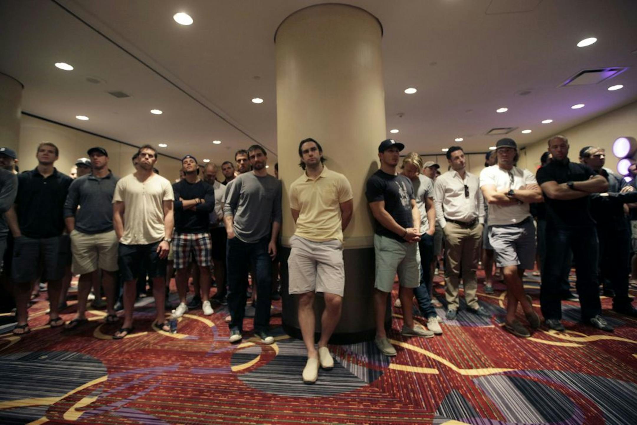NHL hockey players watch as NHL Players Association executive director Donald Fehr speaks at a news conference in New York, Thursday, Sept. 13, 2012. With a lockout looking increasingly certain, the NHL players' union meets Thursday followed by an owners' meeting at league headquarters with Commissioner Gary Bettman.