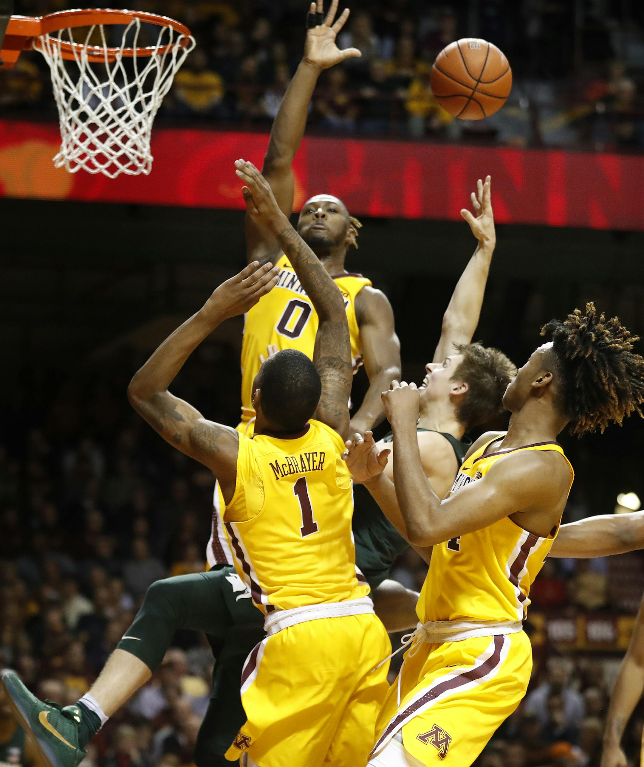 Michigan State Spartans guard Matt McQuaid (20) could not scored over Minnesota Golden Gophers guard Akeem Springs (0), and guard Dupree McBrayer (1) in the first half at Williams Arena Tuesday December 27,2016 in Minneapolis, MN] The Minnesota Golden Gophers hosted Michigan St. at Williams Arena. Jerry Holt / jerry. Holt@Startribune.com