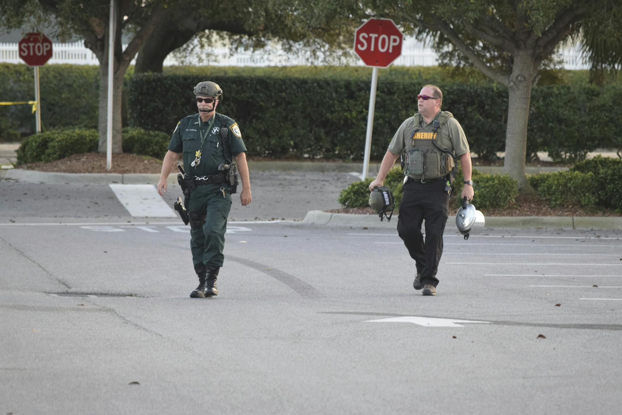 Deputies with the Bay County Sheriff's Office carry away a pressure cooker from where it was left in the parking lot of a Target store in Destin, Fla. (Annie Blanks/Northwest Florida Daily News via AP) ORG XMIT: FLPLA101