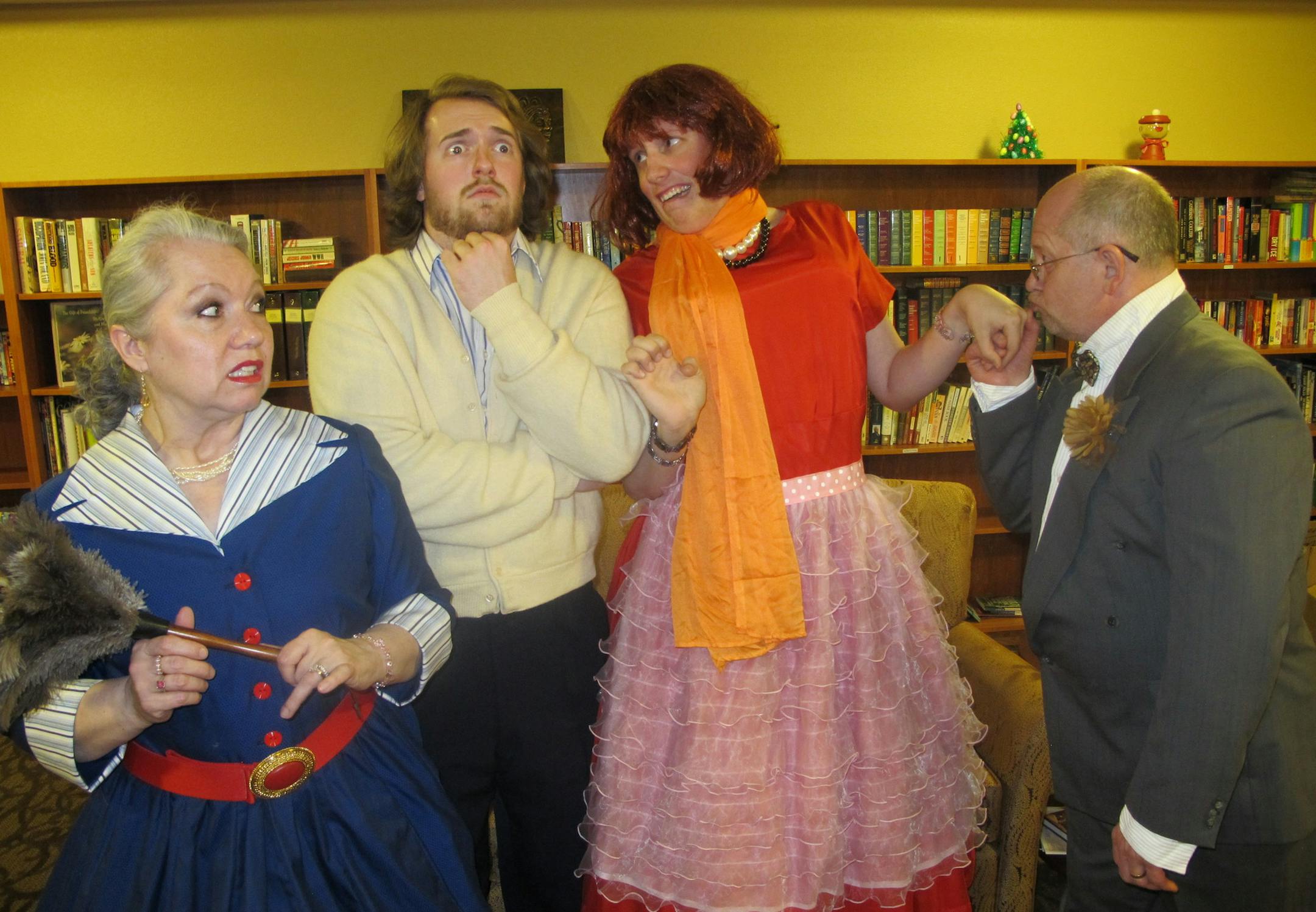 credit: Coon Rapids Community Players Cast members in a scene from "Here Come the Brides"; from left: Kim Jaskier (Aunt Ellen); Michael Johnson (Jimmy), Grant Hooyer (Bill), and Michael Osland (Uncle Dan). Photo description: Bill trying to pretend to be Jimmy's new bride for Uncle Dan's impromptu visit as Bill's Aunt Ellen and Jimmy nervously observe.