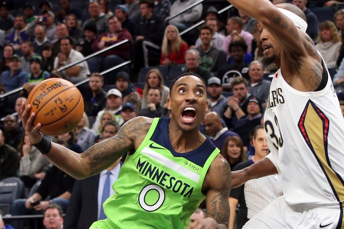 Minnesota Timberwolves' Jeff Teague, left, drives around New Orleans Pelicans' Dante Cunningham in the first half of an NBA basketball game Saturday, Feb. 3, 2018, in Minneapolis. (AP Photo/Jim Mone)