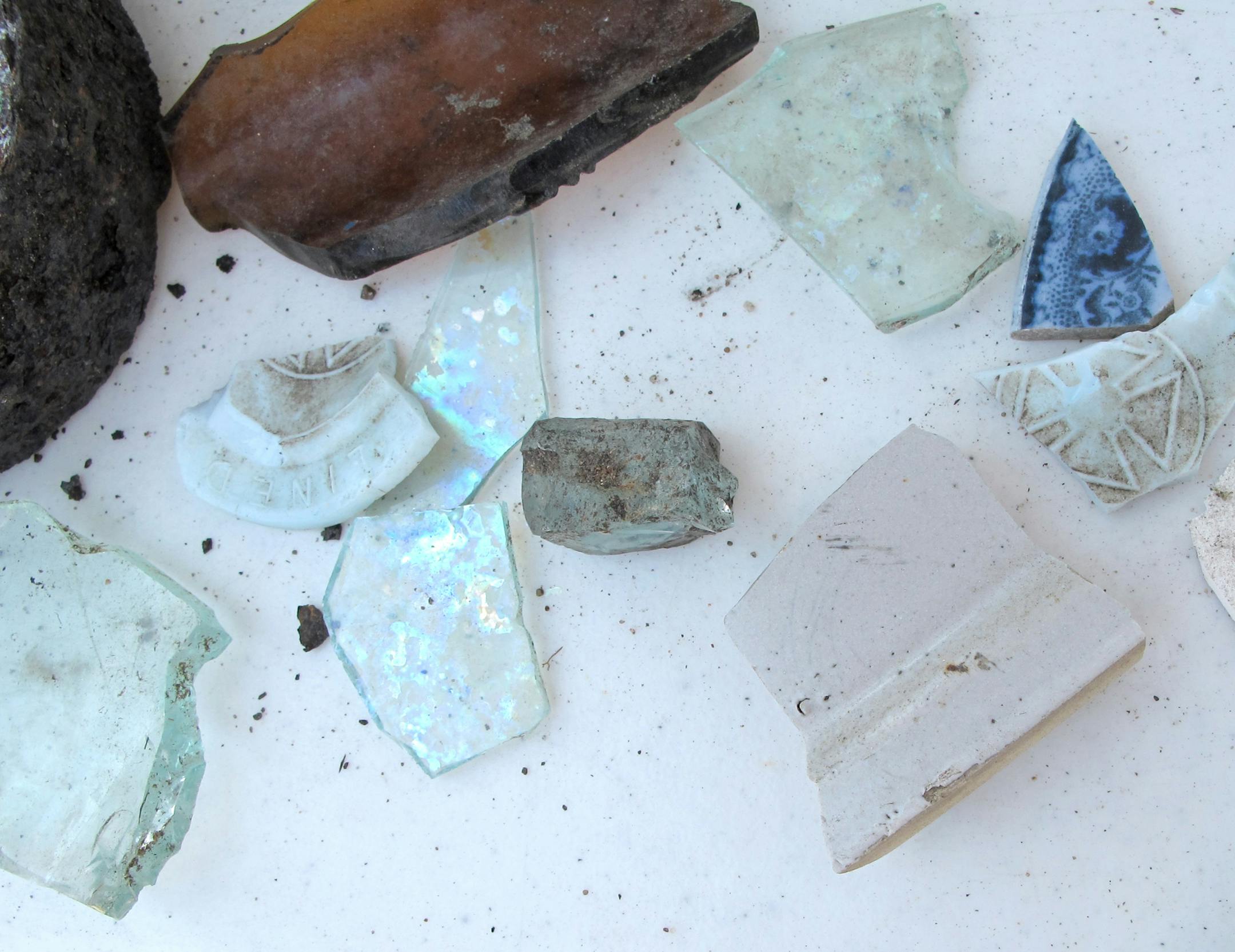 Shards of glass and pottery fragments were unearthed Thursday, but diggers were hoping to find evidence going back even further in local history. Other treasures included a carbide lamp, prehistoric pottery piece and a glass bottle intact with a small brush still inside it. Photo: Jim Anderson/Star Tribune