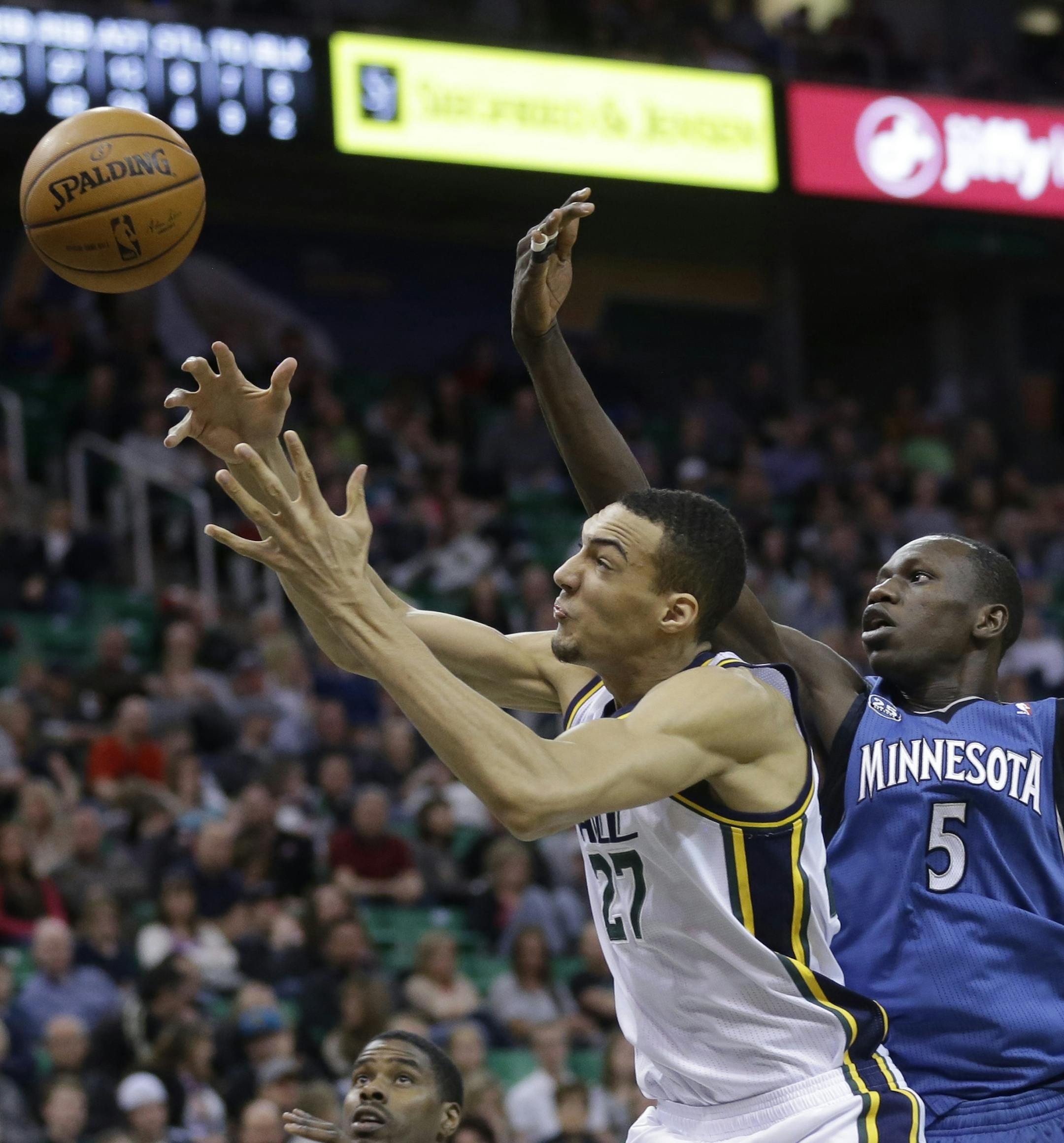 Utah Jazz's Rudy Gobert (27) and Minnesota Timberwolves' Gorgui Dieng (5) reach for a rebound in the second half of an NBA basketball game Saturday Feb. 22, 2014, in Salt Lake City. (AP Photo/Rick Bowmer)