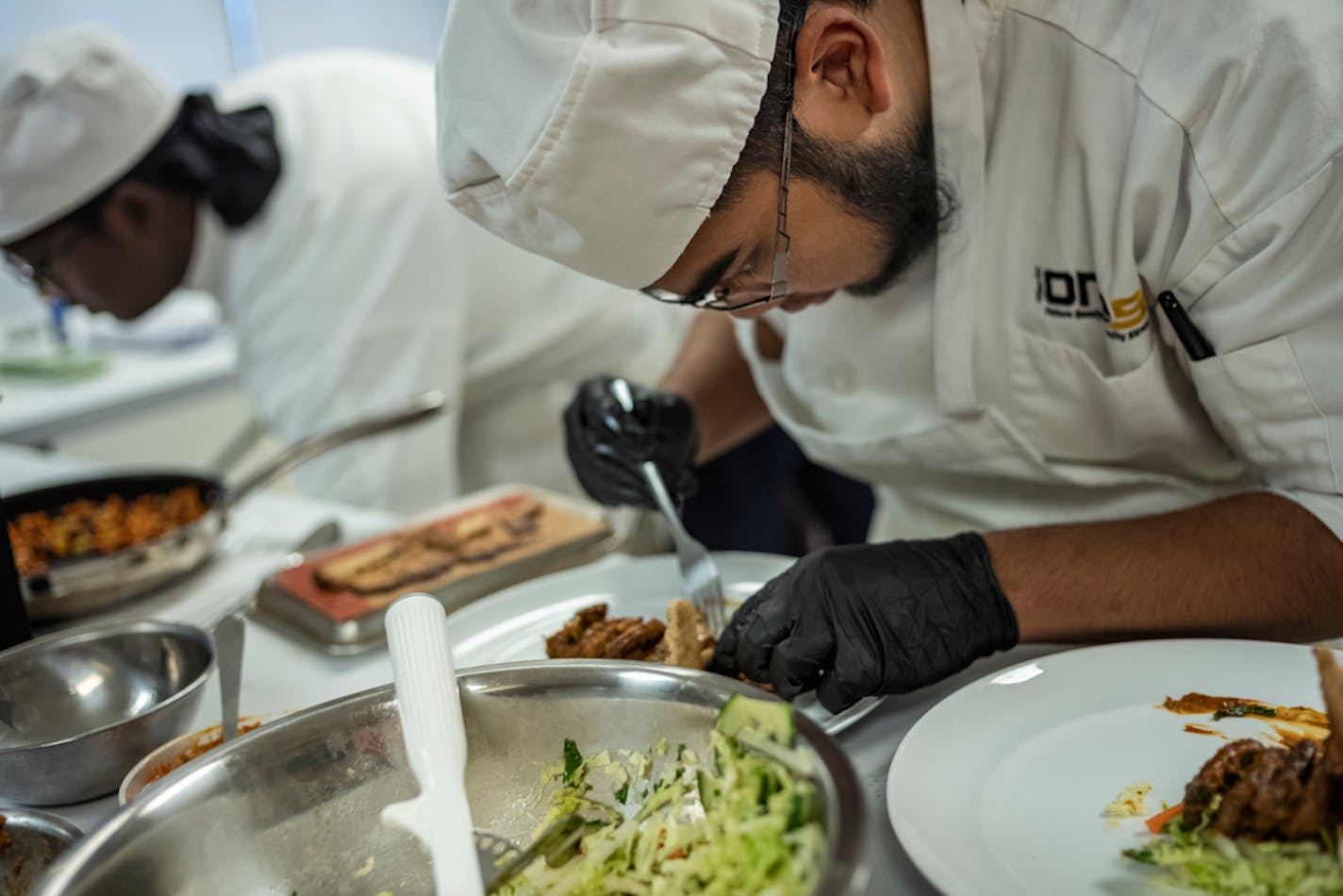 Felix Bunnithi arranges his beef salad plate.] A story on the ProStart Invitational, a high school culinary competition. The story will focus on the four-member Burnsville High School team entry and their three-course meal.RICHARD TSONG-TAATARII ¥ richard.tsong-taatarii@startribune.com