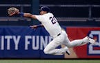 FILE - In this July 27, 2016, file photo, Minnesota Twins center fielder Eddie Rosario leaves the turf to catch a fly ball by Atlanta Braves' Ender In