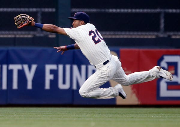 FILE - In this July 27, 2016, file photo, Minnesota Twins center fielder Eddie Rosario leaves the turf to catch a fly ball by Atlanta Braves' Ender In
