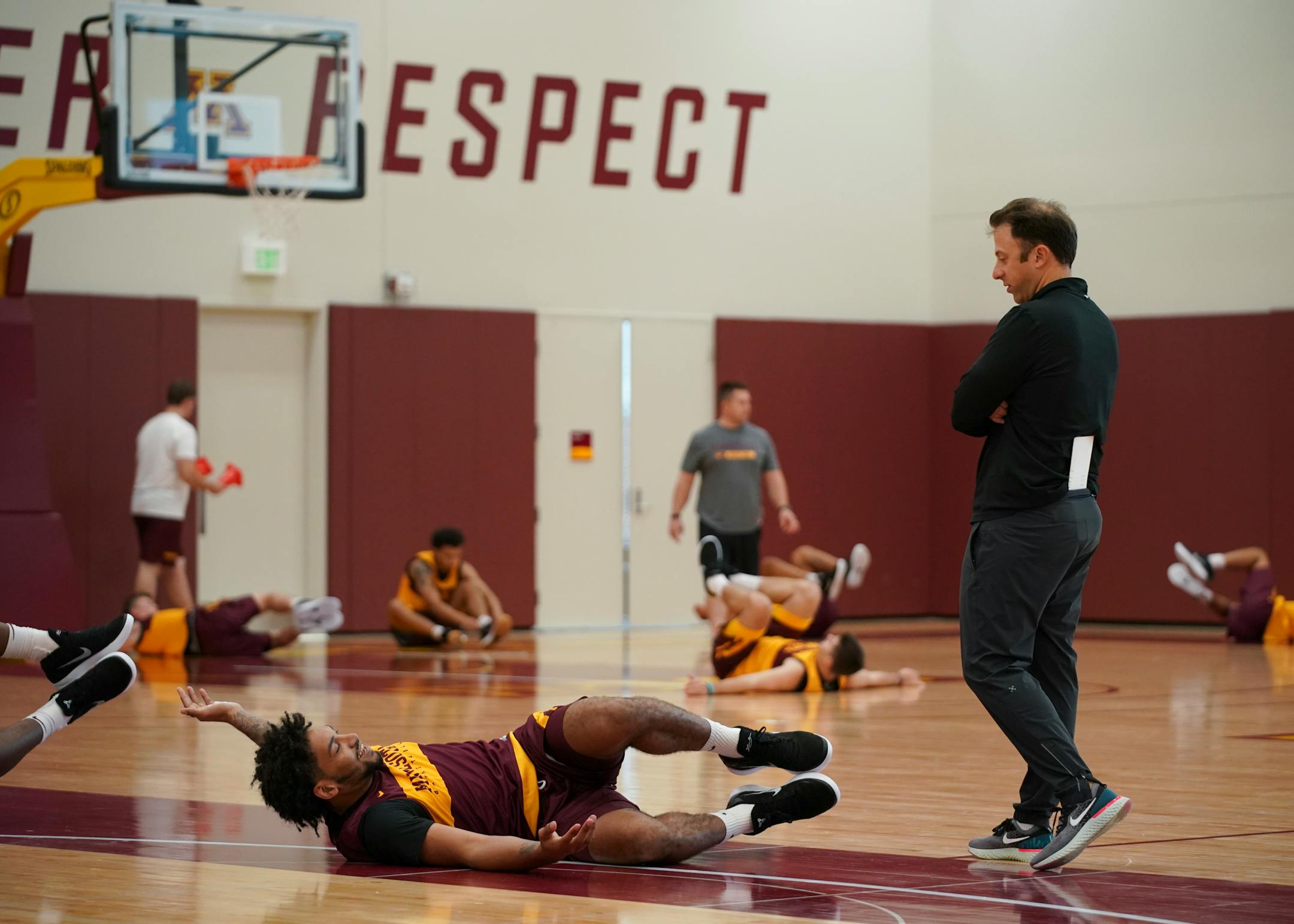 Minnesota Gophers basketball coach Richard Pitino spoke with Jordan Murphy while the team stretched at the start of practice on September 25, 2018 at the new basketball facility.