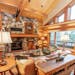 Windows let ample light into the Ely log home while providing vistas of the woods and Burntside Lake. A stone wood-burning fireplace keeps things cozy