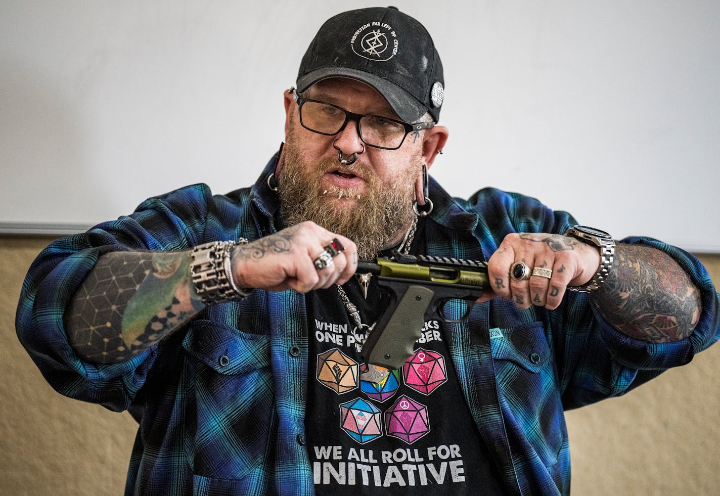 Mike Sharp shows how to handle a gun safely in Sharpe caters to a growing group of gun owners — urban liberals, many of whom identify as women, LGBTQ+, or people of color — and is working to take the toxic masculinity out of gun culture. ] RICHARD TSONG-TAATARII • richard.tsong-taatarii@startribune.com