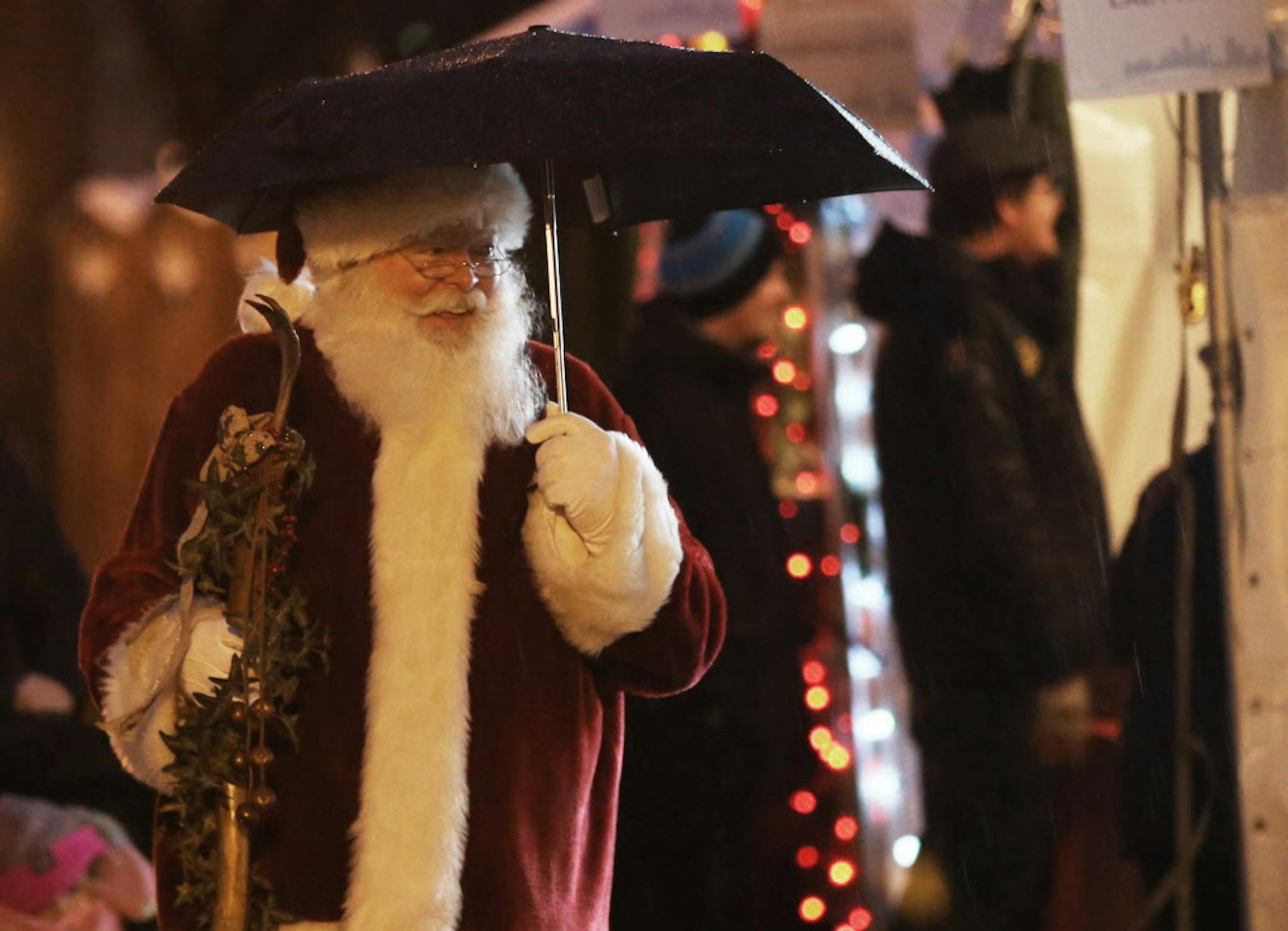 Holidazzle kicked off at Friday, Nov. 23, 2018, at Loring Park in Minneapolis, MN. Here, Santa sported an umbrella while briefly strolling the Holidazzle grounds.] DAVID JOLES ï david.joles@startribune.com Holidazzle is a Downtown Minneapolis free holiday destination located in Loring Park that features ice skating, music, movies, fireworks and fun for all ages.