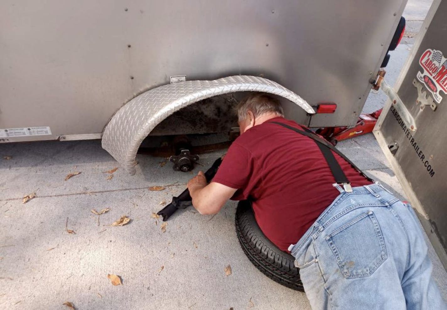 Will Ammermann fixed a tire on the trailer of Arvis Stubbs in Raymond, Minn.