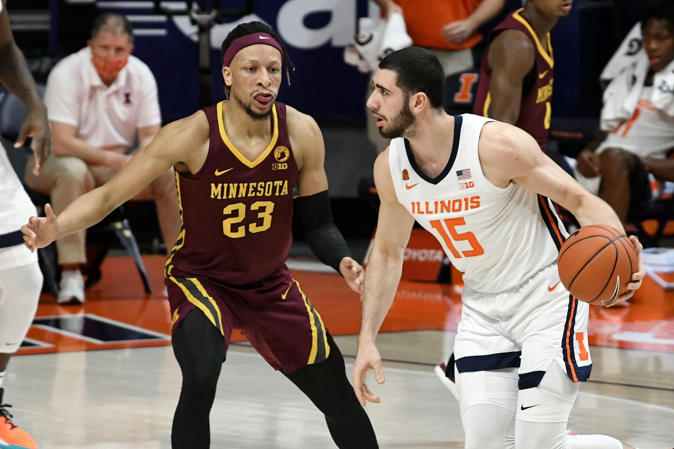 Illinois forward Giorgi Bezhanishvili (15) moves the ball past Minnesota's forward Brandon Johnson (23) in the first half of an NCAA college basketball game Tuesday, Dec. 15, 2020, in Champaign, Ill. (AP Photo/Holly Hart)