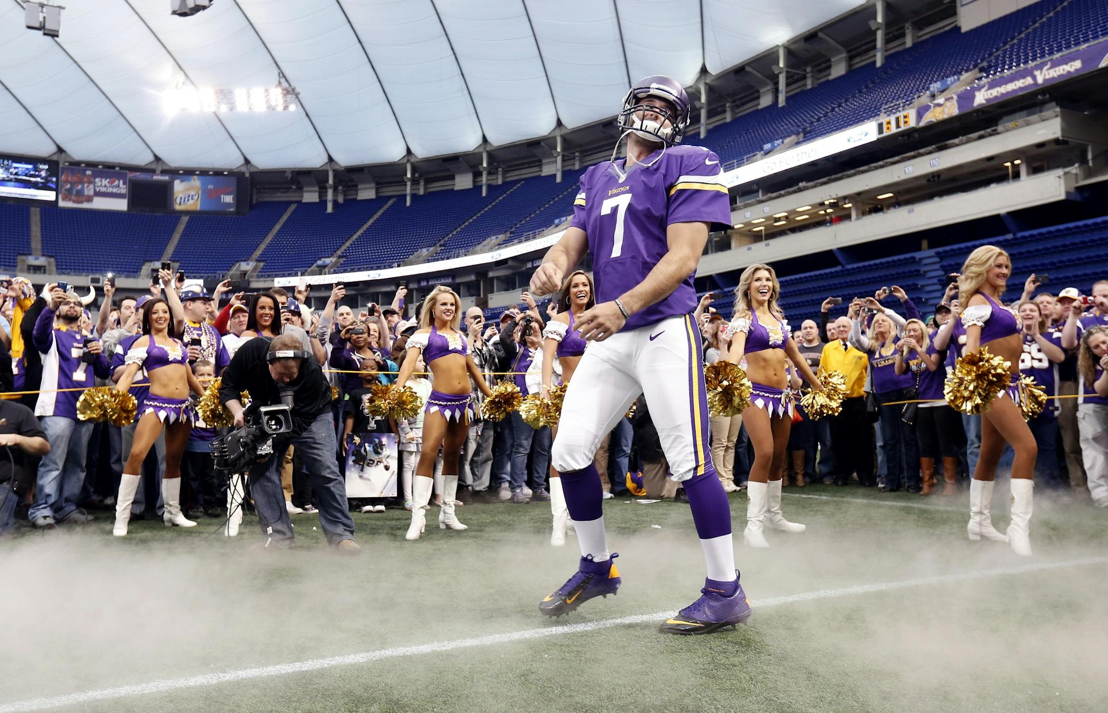 Minnesota Vikings quarterback Christian Ponder (7) ran out of the during the unveiling of the teams new uniforms at the Vikings raft party at The Metrodome on Thursday.