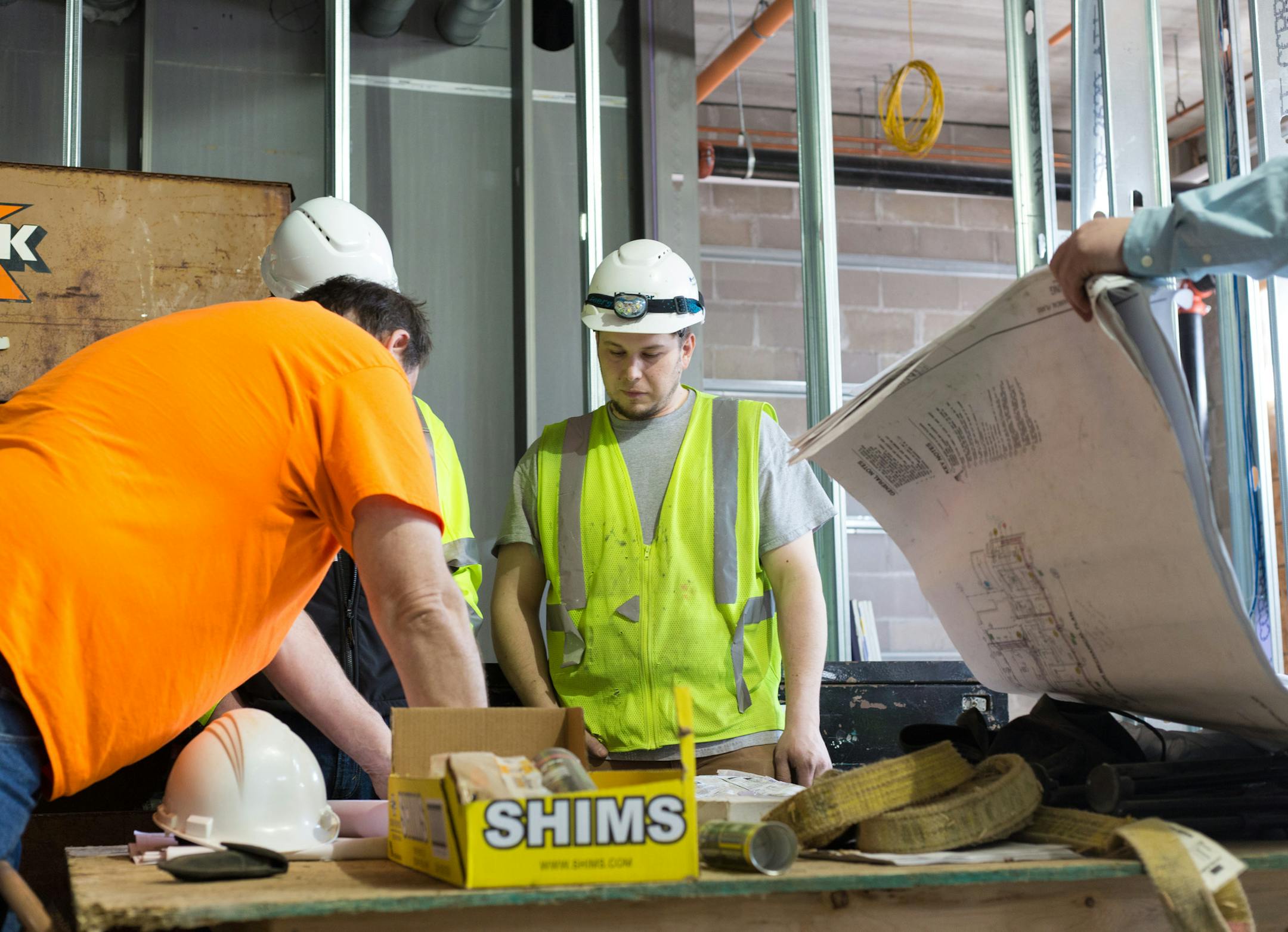 Josh Wakefield, center, looks at plans for the Beacon Interfaith Housing Collaborative's 44-unit Prior Crossing under construction St. Paul, Wednesday afternoon. The Housing is projected to be complete in September, 2016. ] Elizabeth Brumley special to the Star Tribune * Gov. Mark Dayton's bonding proposal earmarks a record $70 million for housing infrastructure bonds, which can be used for new supportive housing construction. Beacon Interfaith Housing Collaborative's 44-unit Prior Crossing, now