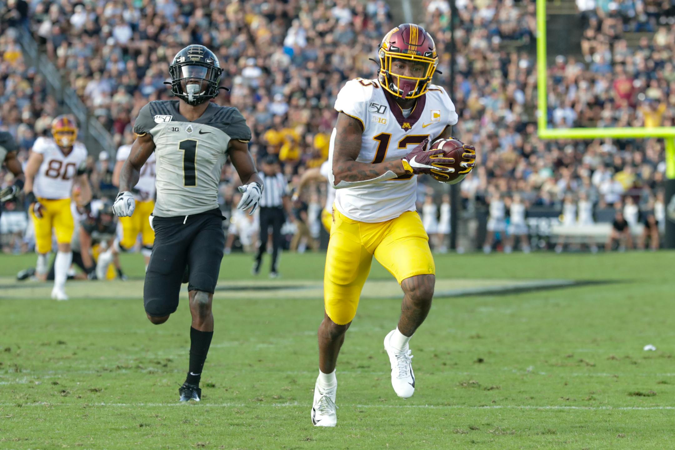Gophers wide receiver Rashod Bateman makes a catch in front of Purdue cornerback Dedrick Mackey on his way to a touchdown during the second half Saturday.
