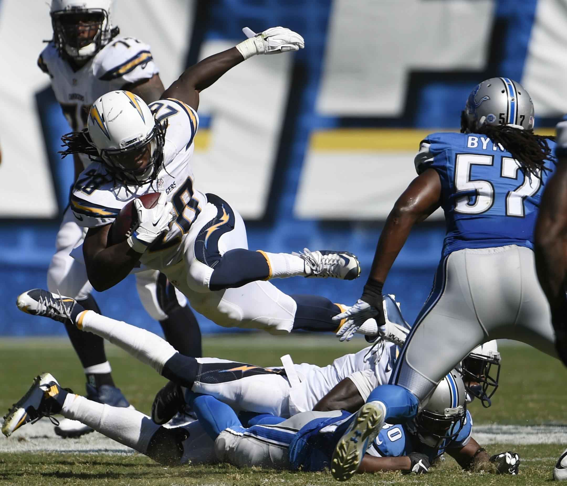 San Diego Chargers running back Melvin Gordon, center, leaps over players as he runs against the Detroit Lions during the second half of an NFL football game Sunday, Sept. 13, 2015, in San Diego. (AP Photo/Denis Poroy)